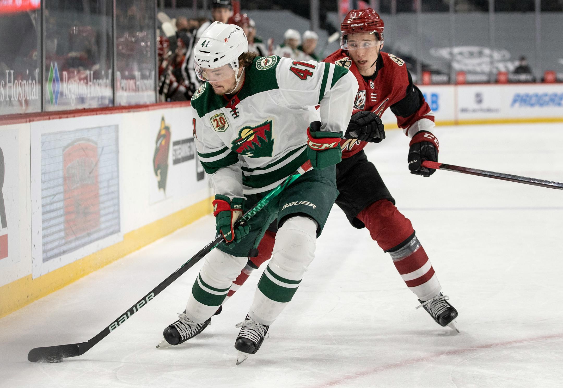 Luke Johnson (41) of the Minnesota Wild and Tyler Pitlick (17) of the Arizona Coyotes fought for the puck in the first period.