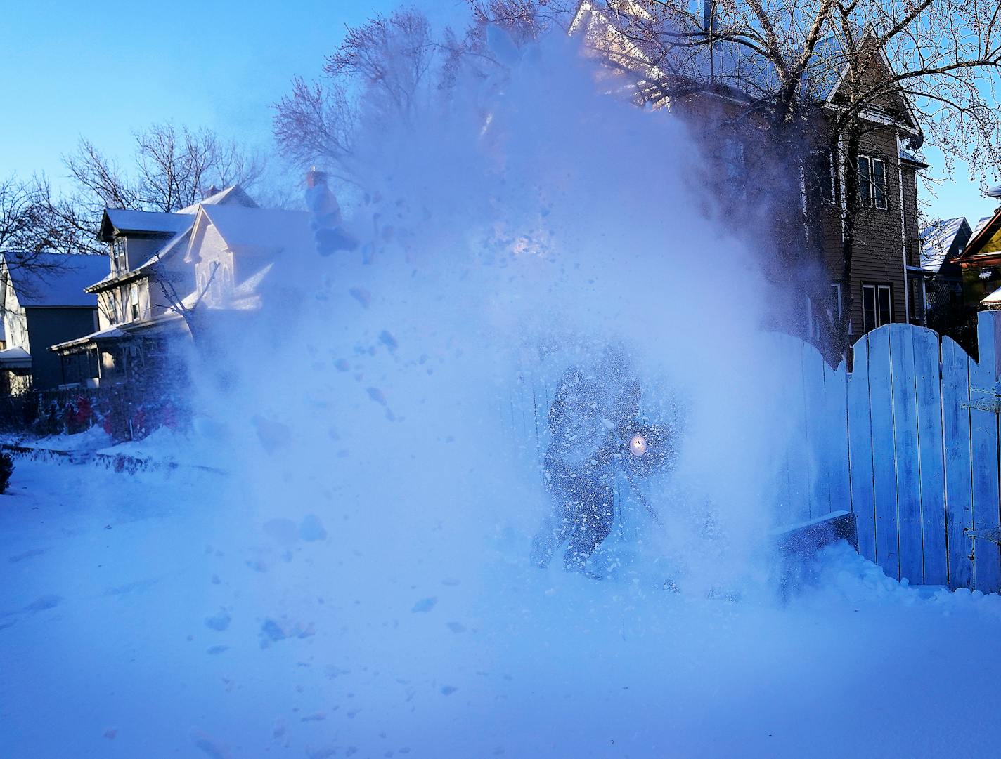 Jonathan Aurand of Minneapolis battled wind, drifting snow and below zero temps while clearing the sidewalk Thursday in south Minneapolis. ]