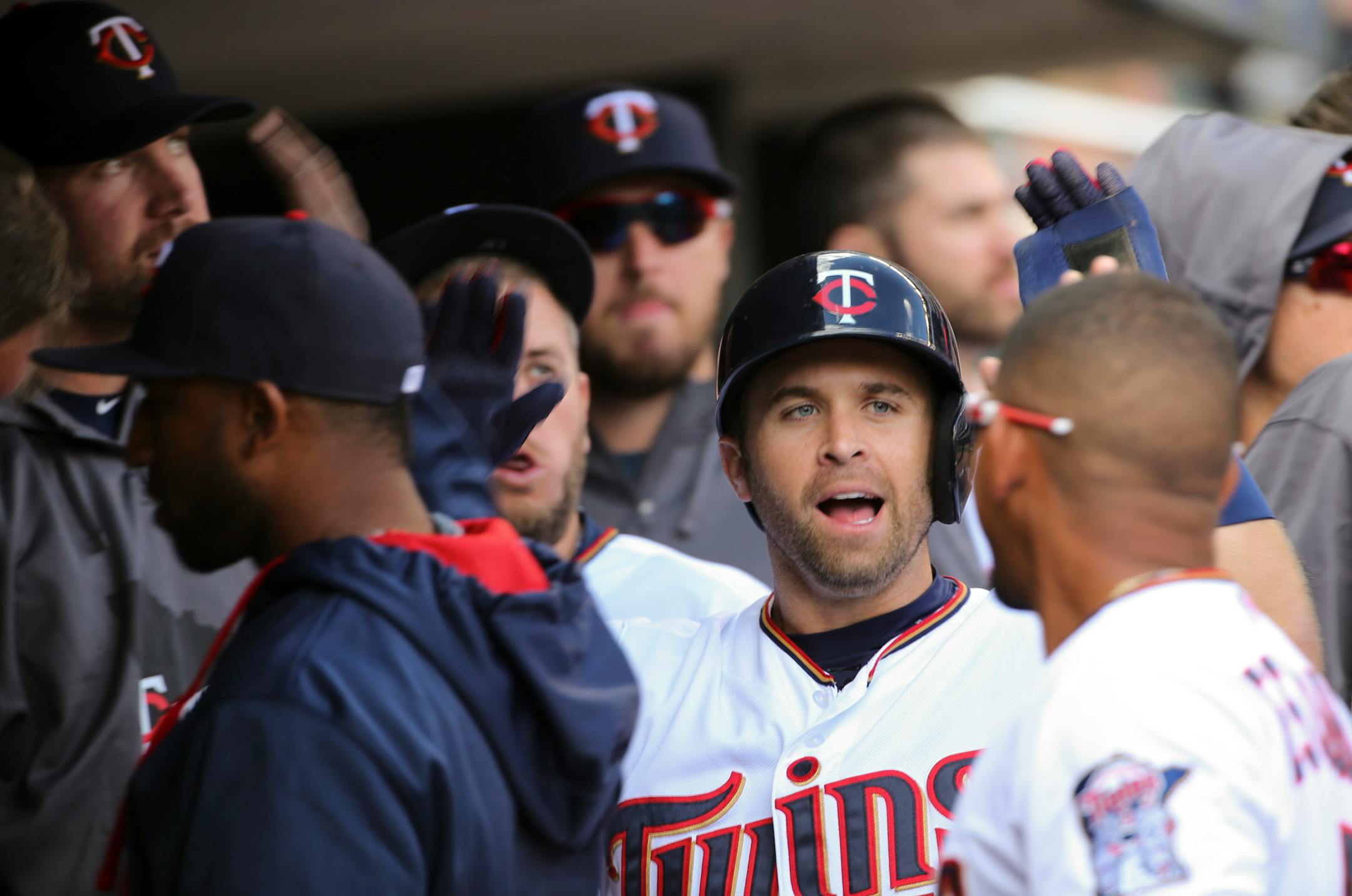 Twins second baseman Brian Dozier was congratulated in the dugout after scoring in the first inning on a Kennys Vargas single Monday afternoon at Target Field. ] JEFF WHEELER � jeff.wheeler@startribune.com The Minnesota Twins faced the Kansas City Royals in their home opener Monday afternoon, April 13, 2015 at Target Field in Minneapolis.