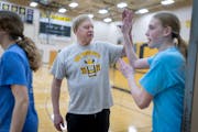 New London-Spicer girls basketball coach Mike Dreier high-fives his players after practice earlier this month in New London.