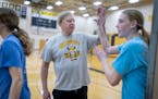 New London-Spicer girls basketball coach Mike Dreier high-fives his players after practice earlier this month in New London.