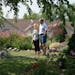 Dan and Nancy Engebretson, with their dog Aubrey, stand in the common area that they garden next to their home in Elysian, Minnesota on July 31, 2014.