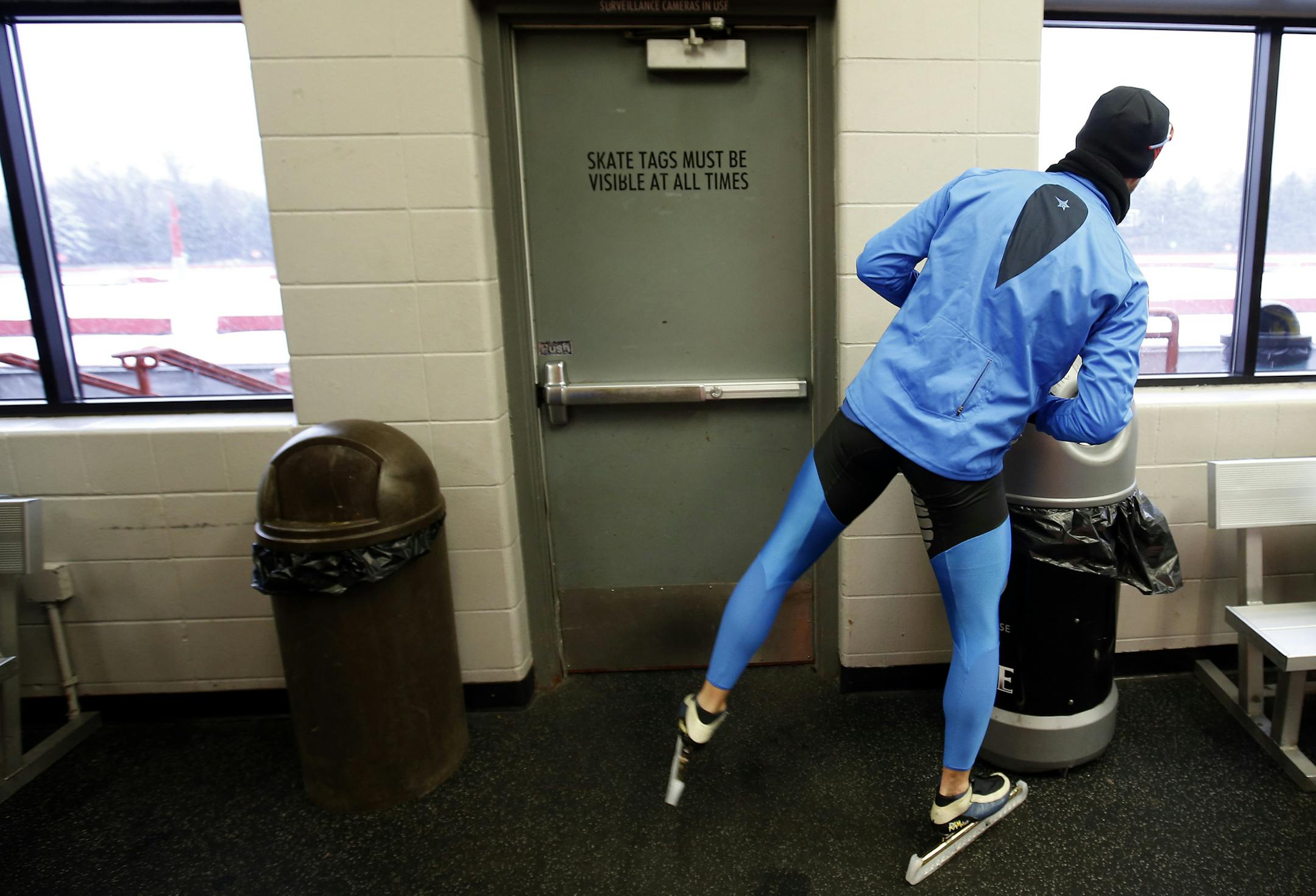 Paul Dyrud checked the weather conditions on a snowy day before a training session at the John Rose Oval in Roseville on Tuesday. Dyrud is an Olympic speed skating hopeful. ] CARLOS GONZALEZ cgonzalez@startribune.com - December 3, 2013, Roseville, Minn., John Rose Oval, Olympics Hopeful speed skater Paul Dyrud ORG XMIT: MIN1312041728460929