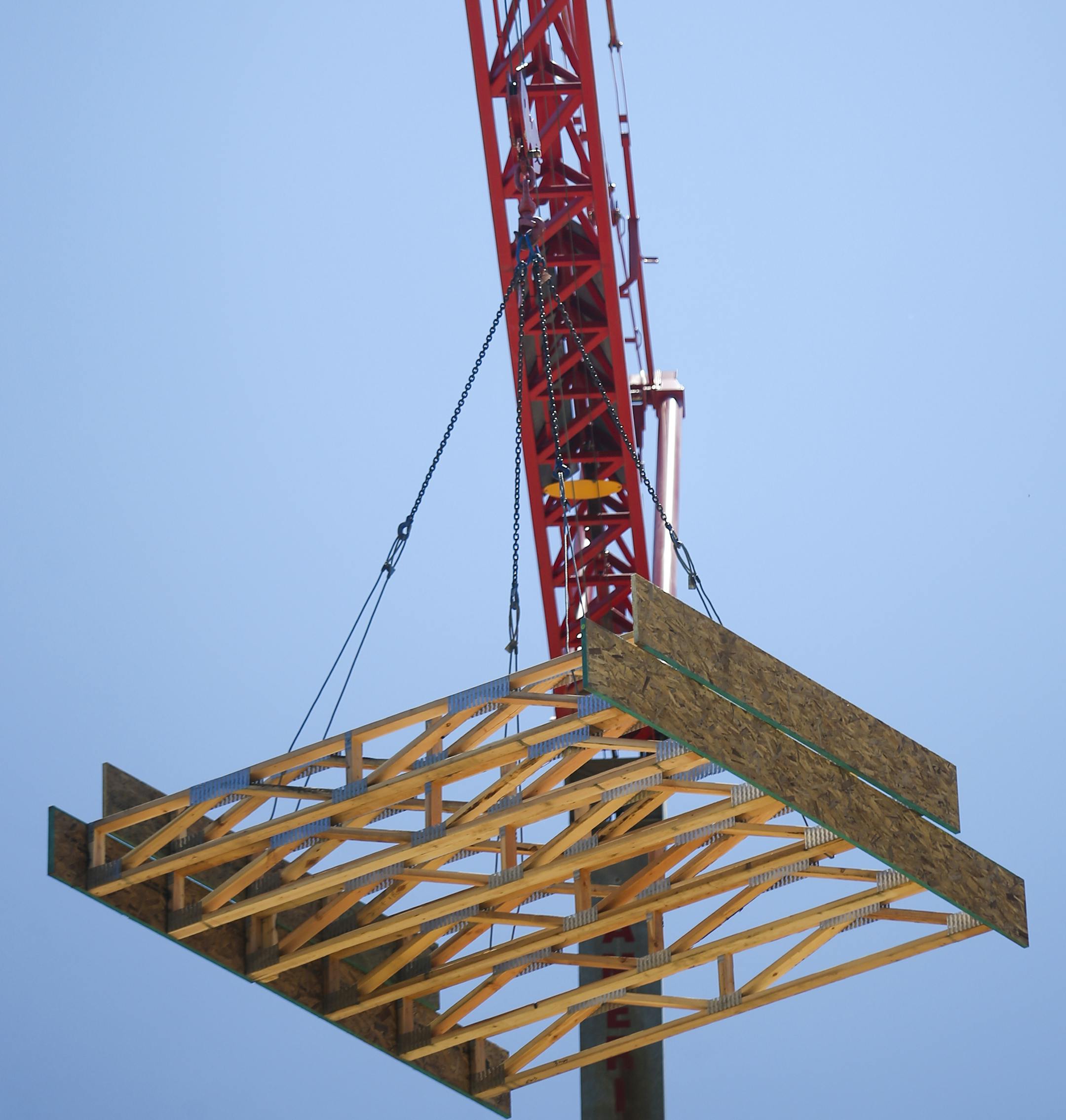 Wood paneling is brought up by a crane to the top level of Hello Apartments. ] Timothy Nwachukwu • timothy.nwachukwu@startribune.com Construction work of Hello Apartments is performend on Friday, July 22, 2016. Though the apartment building is scheduled to be completed by December 2016, regulators are exploring whether substandard wood is being used.