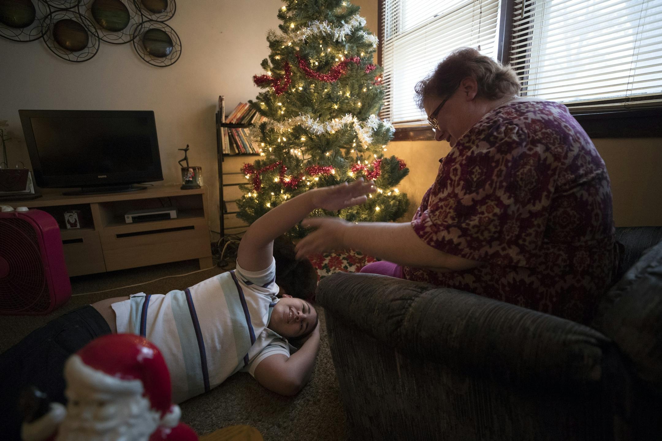 Cora Mustin played with her 15-year-old son Jordan Mustin in their apartment after he arrived home from school Thursday December 14, 2017 in Mounds View, MN. Jordan has autism and a history of violent outbursts toward himself and family.