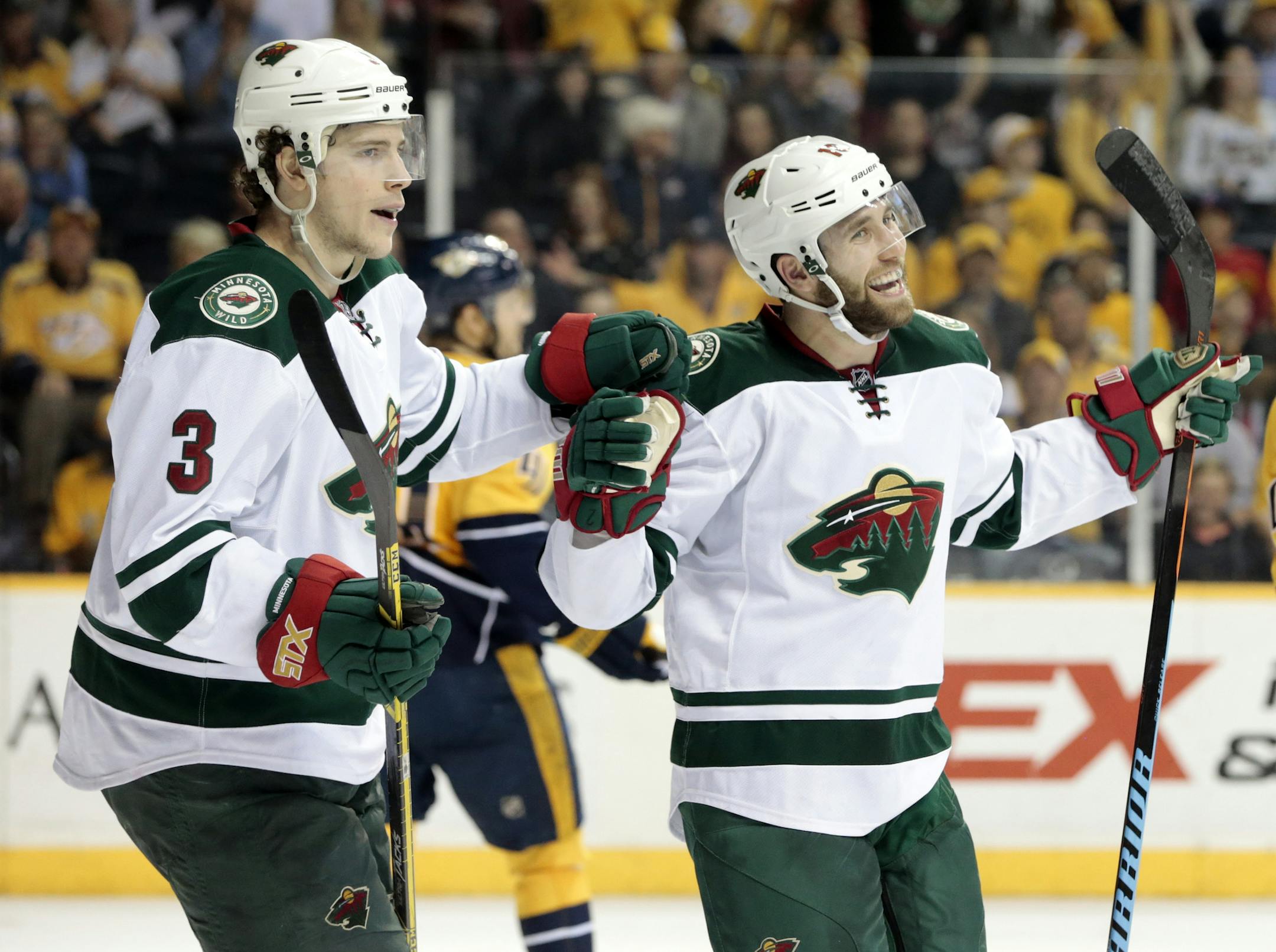 Minnesota Wild left wing Jason Zucker, right, celebrates with Charlie Coyle (3) after Zucker scored a goal against the Nashville Predators in the second period of an NHL hockey game Thursday, April 9, 2015, in Nashville, Tenn. (AP Photo/Mark Humphrey)