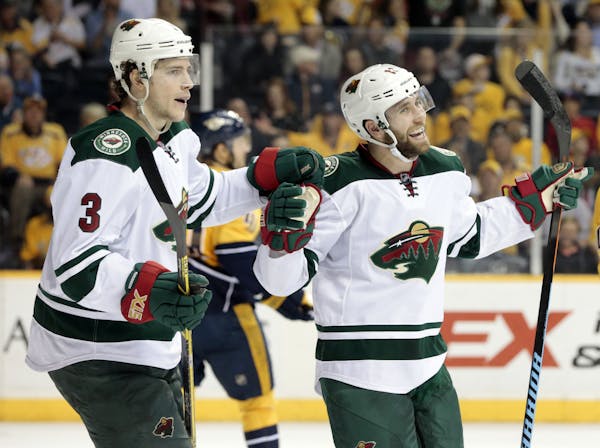Minnesota Wild left wing Jason Zucker, right, celebrates with Charlie Coyle (3) after Zucker scored a goal against the Nashville Predators in the seco