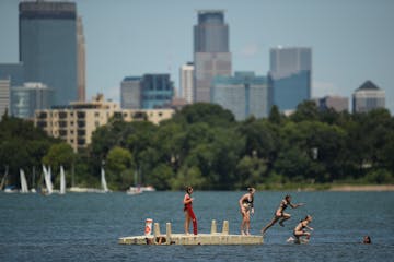 Kids jumped off the raft off Thomas Beach into Lake Bde Maka Ska in July.