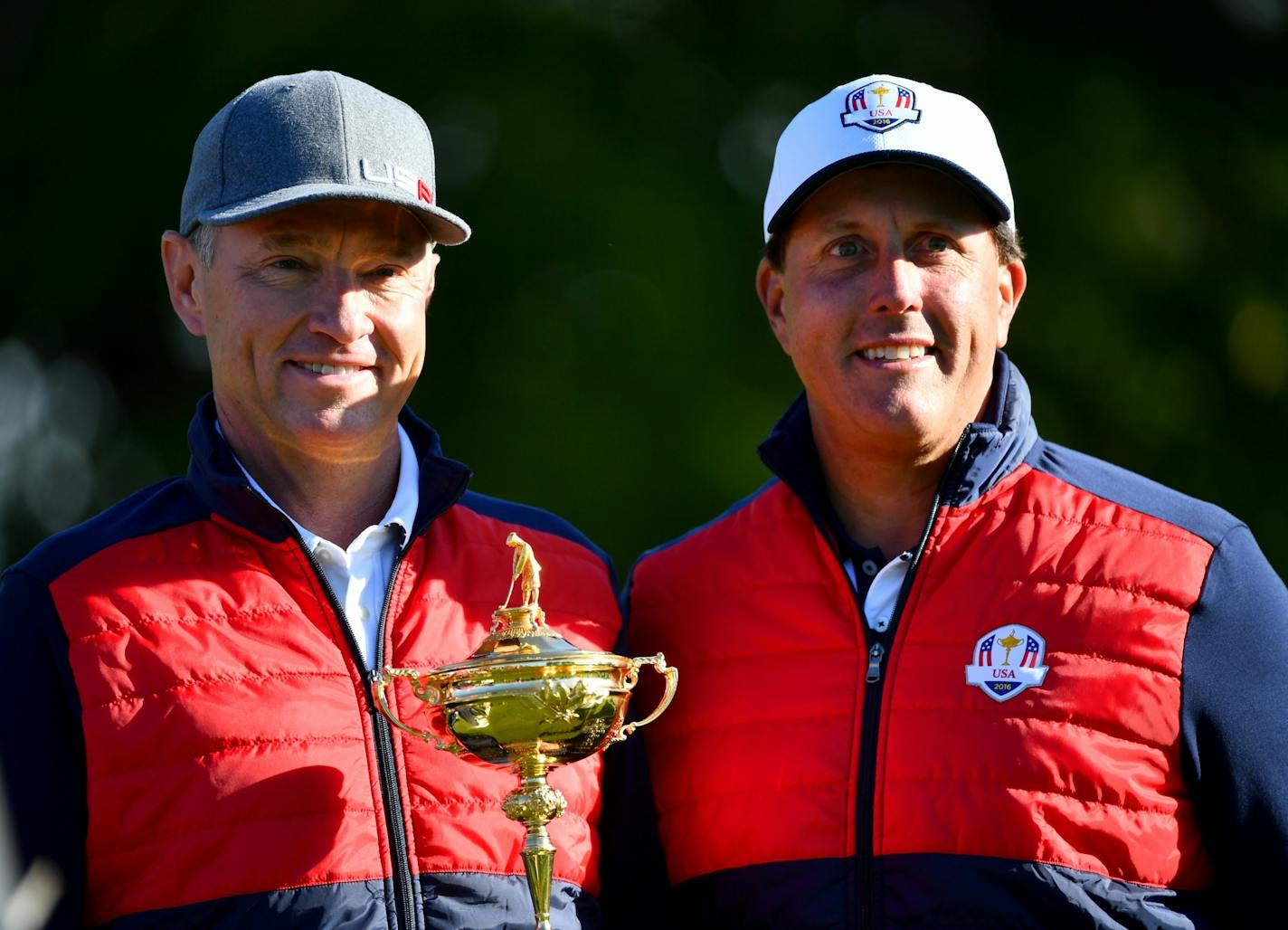 Team USA Captain Davis Love III, left, and Phil Mickelson posed with the Ryder Cup trophy during a team photo session Tuesday morning at Hazeltine National Golf Club.