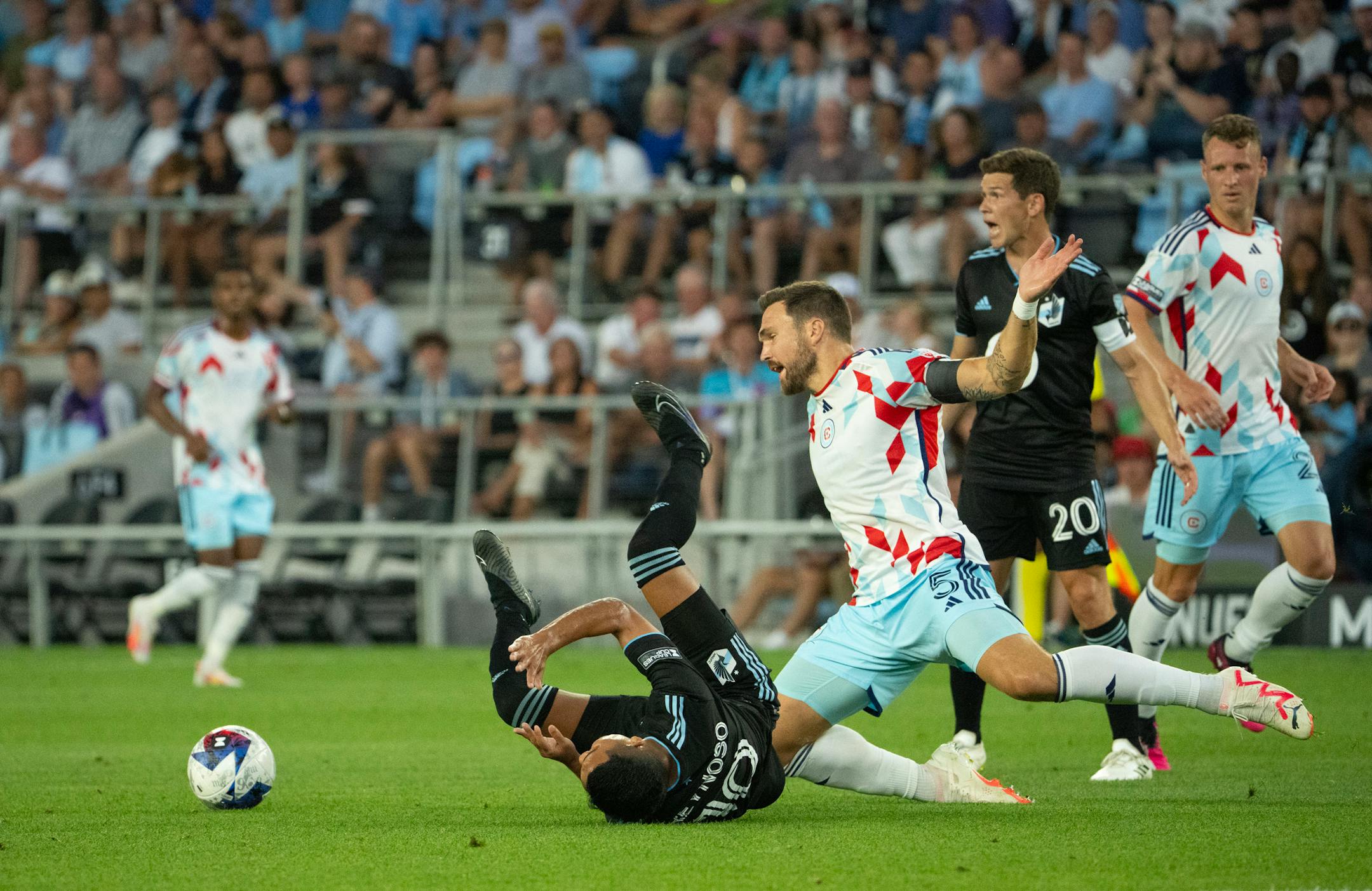 Minnesota United midfielder Emanuel Reynoso (10) was tripped up by Chicago Fire defender Rafael Czichos (5) in the first half. The Minnesota United FC faced the Chicago Fire FC in a Leagues Cup 2023 match.