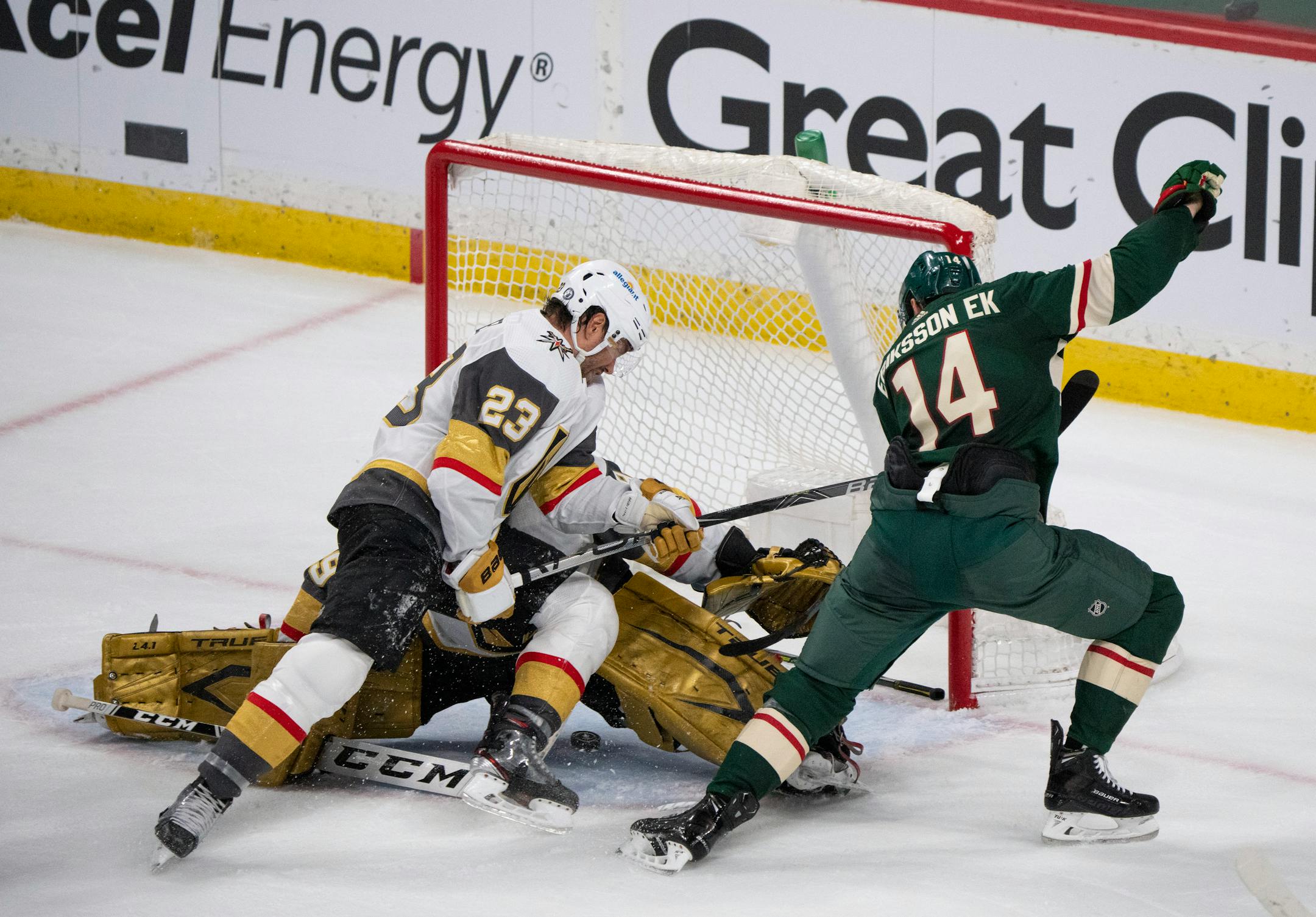 Minnesota Wild center Joel Eriksson Ek (14) slipped the puck under Vegas Golden Knights goaltender Marc-Andre Fleury (29) in the third period, but it didn't go past the goal line as Vegas Golden Knights defenseman Alec Martinez (23) intervened.
