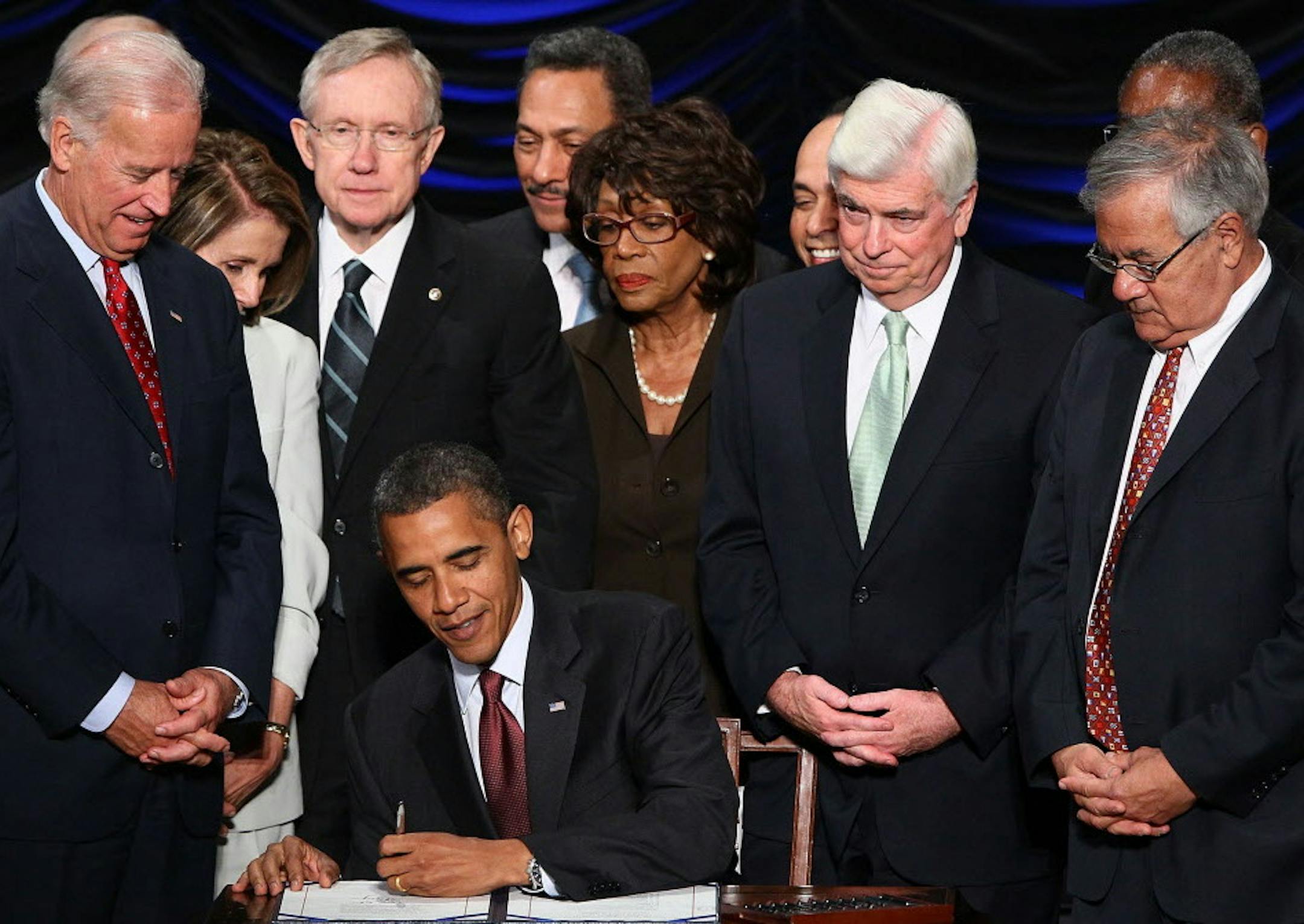 U.S. President Barack Obama signs the Dodd-Frank Wall Street Reform and Consumer Protection Act at the Ronald Reagan Building in Washington, D.C., Wednesday, July 21, 2010. Also pictured, from left, Vice President Joe Biden, Speaker of the House Nancy Pelosi (D-Calif.), Senate Majority Leader Harry Reid (D-Nev.), Rep. Maxine Waters (D-Calif.), Sen. Chris Dodd (D-Conn.) and Rep. Barney Frank (D-Mass.). (Win McNamee/Abaca Press/MCT)