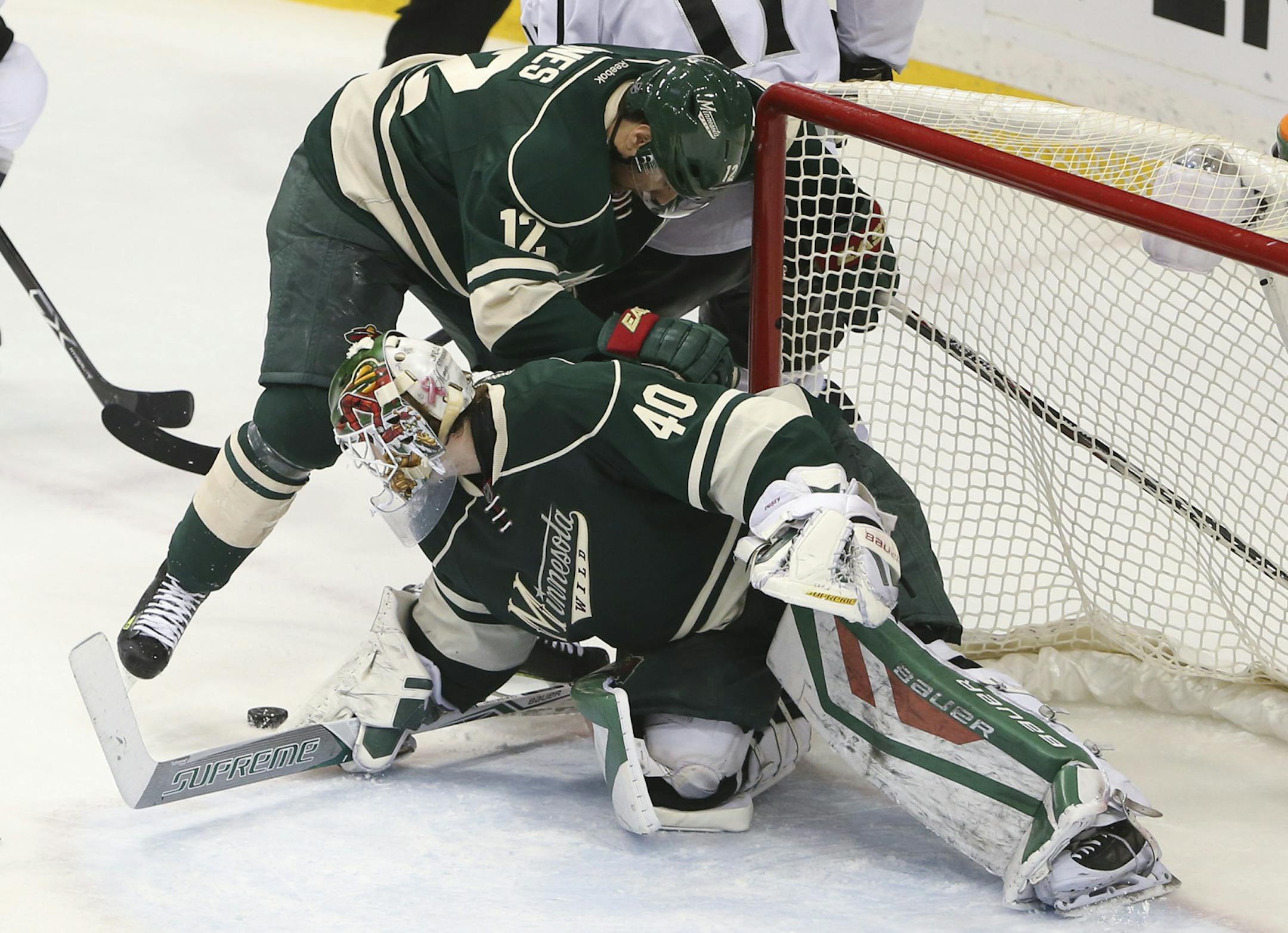 Wild goalie Devan Dubnyk made a sure a loose puck stayed out of the crease while right wing David Jones (12) battled Los Angeles Kings center Anze Kopitar (11) in the third period Tuesday night. ] JEFF WHEELER ï jeff.wheeler@startribune.com The Minnesota Wild beat the Los Angeles Kings 2-1 in an NHL hockey game Tuesday night, March 22, 2016 at Xcel Energy Center in St. Paul.