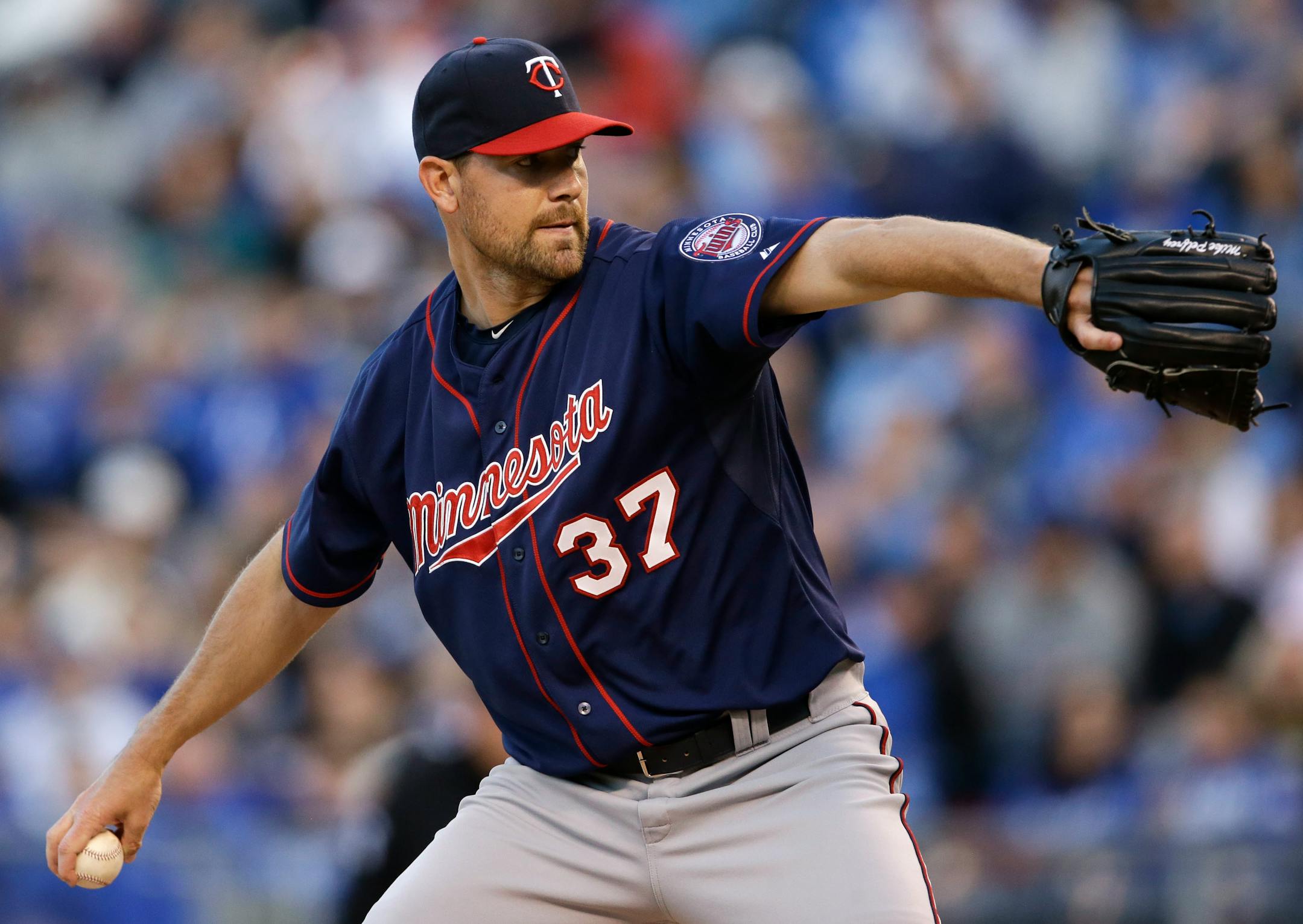 Minnesota Twins starting pitcher Mike Pelfrey delivers to a Kansas City Royals batter during the first inning of a baseball game at Kauffman Stadium in Kansas City, Mo., Wednesday, April 22, 2015. (AP Photo/Orlin Wagner)