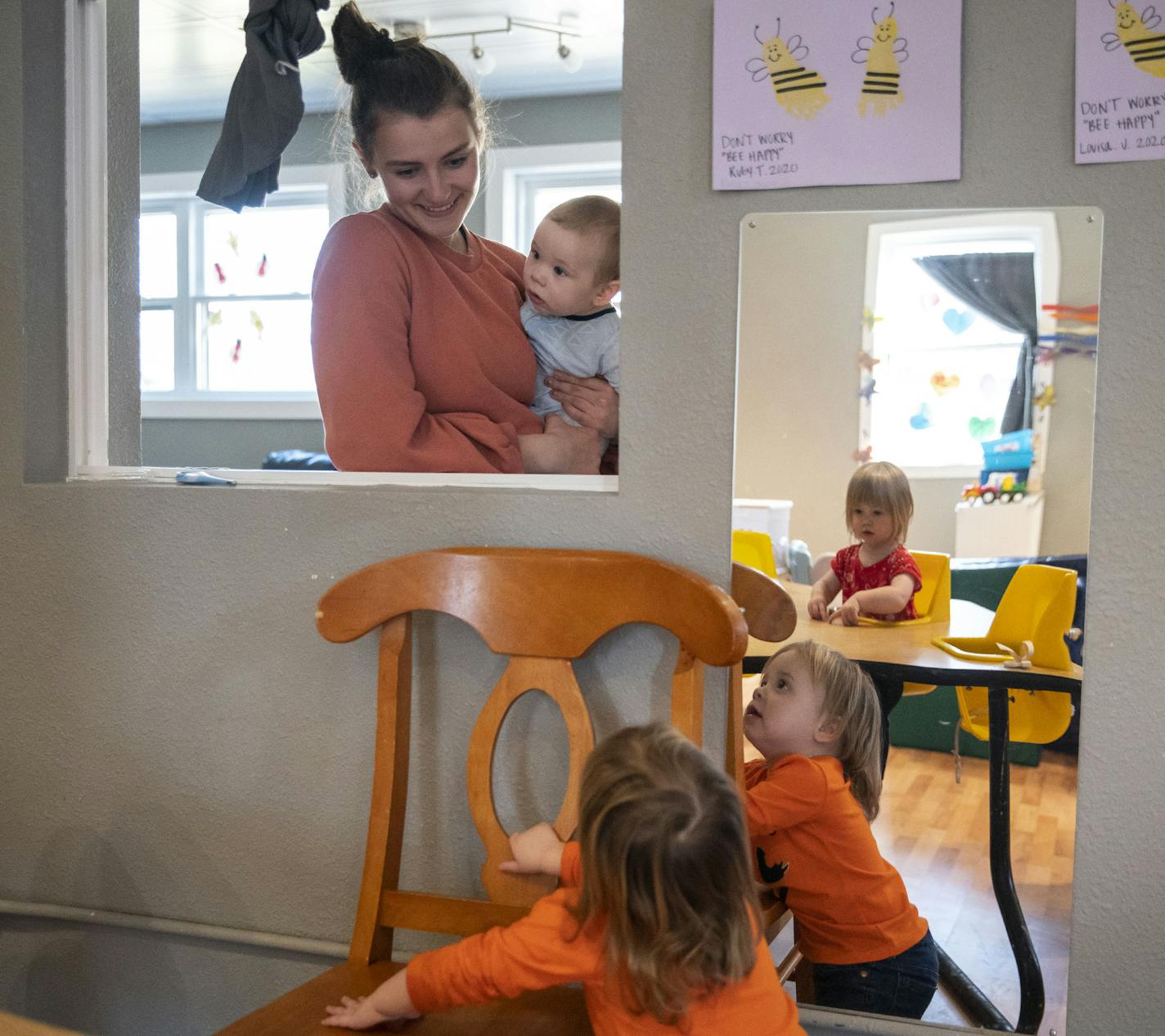 In spite of a drop in the number children at Aunty's Child Care in Duluth, the center caters to parents working on the front line of the virus response. Here, Emily Bates helped children get ready for a snack.