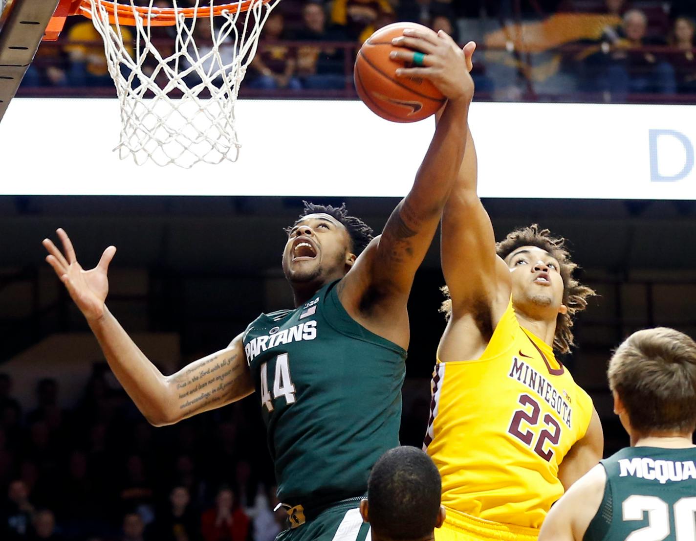 Minnesota's Reggie Lynch, right, tries to knock away a pass to Michigan State's Nick Ward in December.