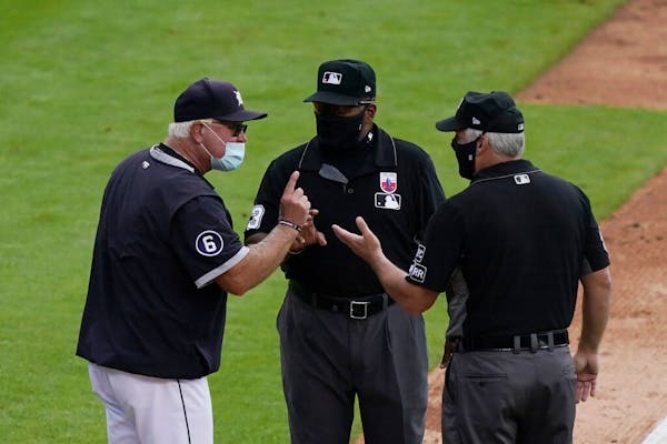 Tigers manager Ron Gardenhire disputes a call with umpire Laz Diaz, center, and Tim Timmons on Sunday.