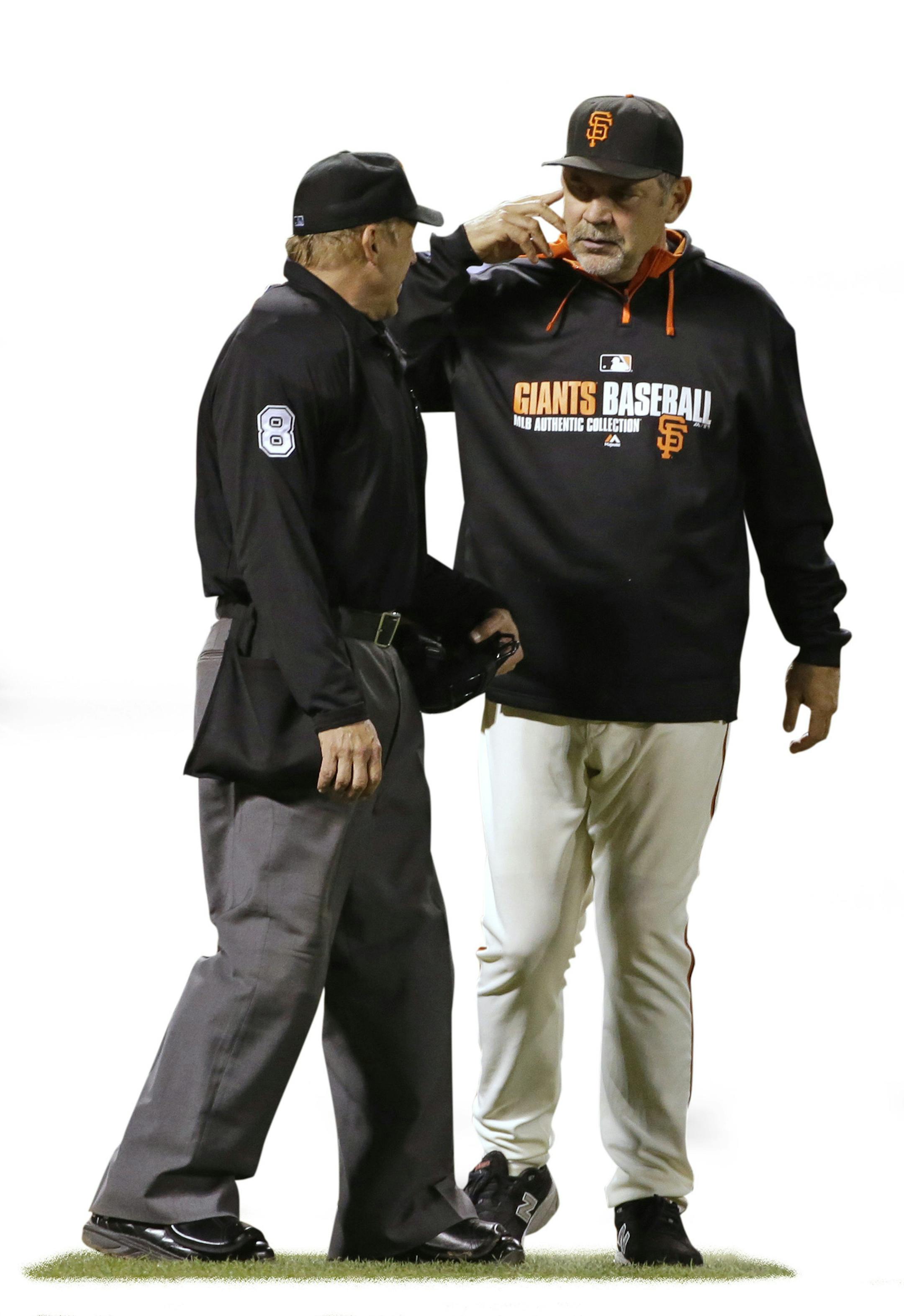 San Francisco Giants manager Bruce Bochy, right, asks home plate umpire Jeff Kellogg, left, for a review of a play on which Cincinnati Reds' Jay Bruce singled on a line drive to Giants right fielder Hunter Pence in the seventh inning of their baseball game Friday, June 27, 2014, in San Francisco. The call was upheld and the Reds' Todd Frazier scored on the play. (AP Photo/Eric Risberg) ORG XMIT: FXPB112