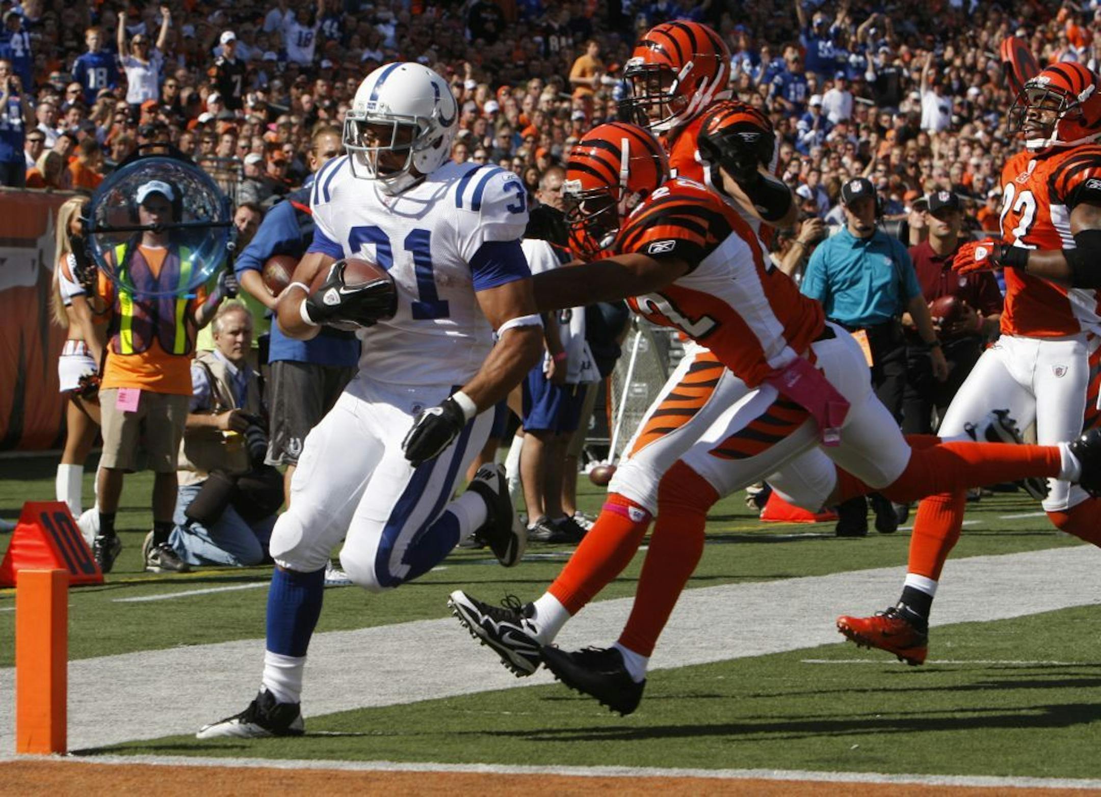 Indianapolis Colts running back Donald Brown (31) scores a touchdown on an 18-yard run past Cincinnati Bengals safety Chris Crocker (42) in the first half of an NFL football game, Sunday, Oct. 16, 2011, in Cincinnati.