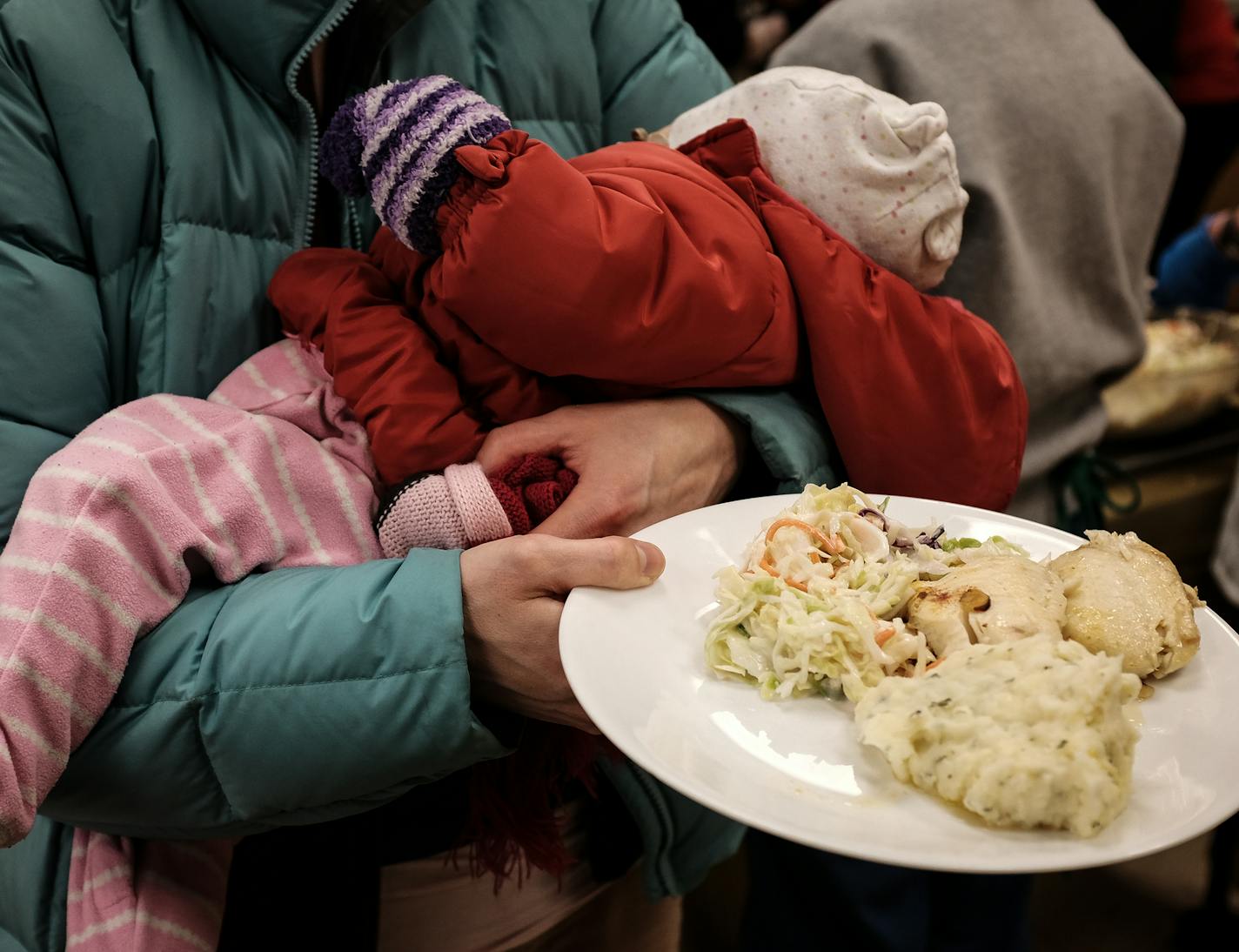 Shannon Voelker held her 4-month old daughter, Sophia, as well as her plate during Friday night's fish fry at St. Albert the Great church. ] AARON LAVINSKY &#xef; aaron.lavinsky@startribune.com Archbishop Bernard Hebda has issued a special dispensation, allowing Catholics to forego their fish-only Fridays on St. Patrick's Day this year. The rule means that celebrants can now eat a burger with their green beer. But what does it mean for those Lent fish fries? We photograph the Friday night fish f