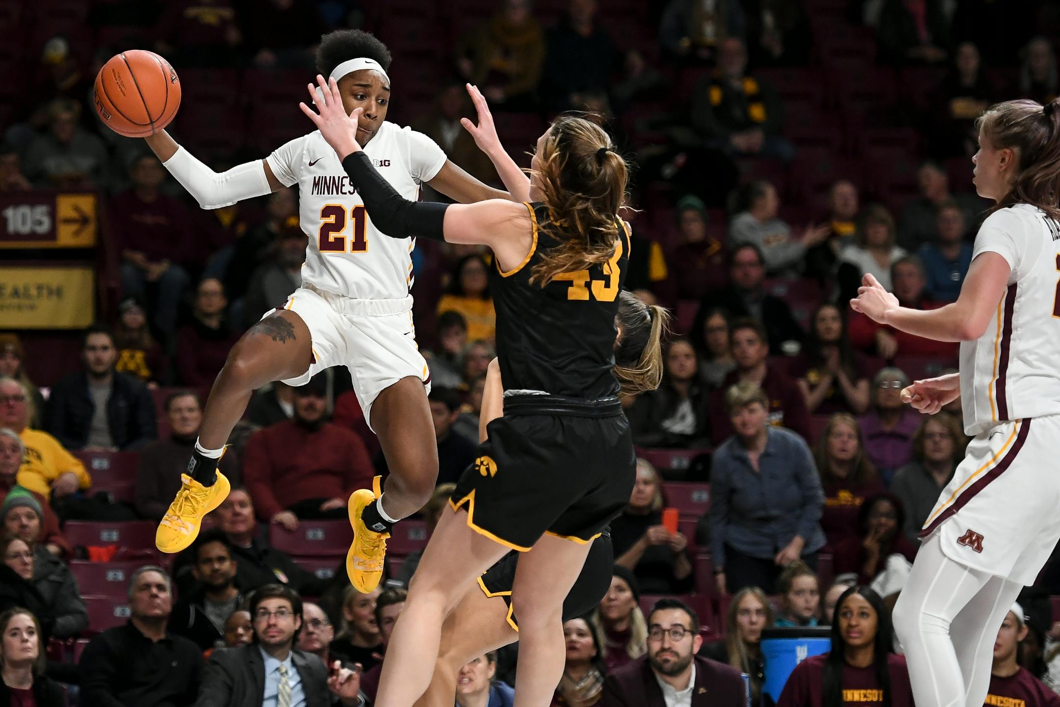 Gophers guard Jasmine Brunson tried to keep the ball in bounds by throwing it off the body of Iowa forward Amanda Ollinger during a game in January.