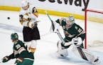 Golden Knights center William Karlsson (71) dodged an outside shot as Wild goaltender Cam Talbot (33) looked to make the save in the first period.