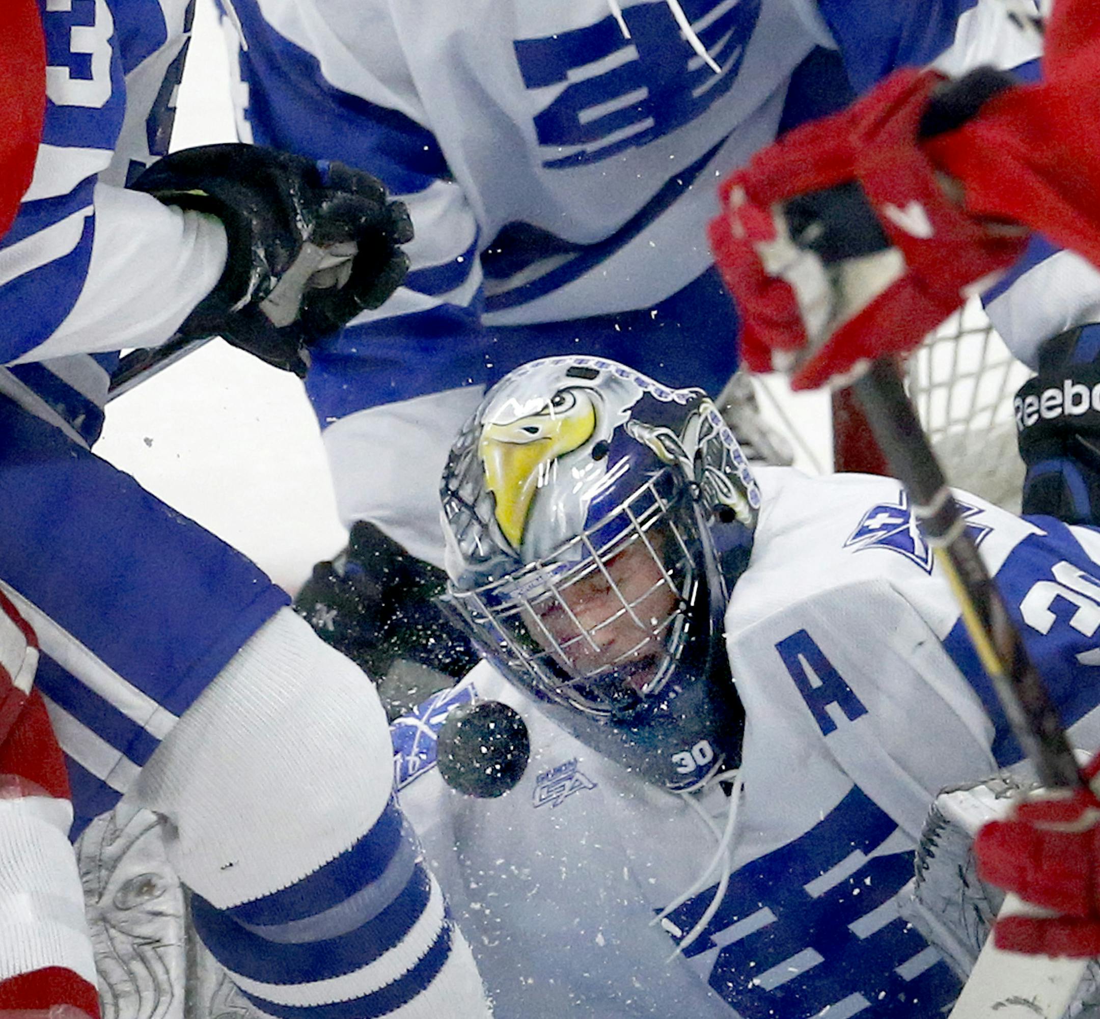 St. Thomas Academy goalie David Zevnik (30) blocked a shot in traffic in the first period. ] CARLOS GONZALEZ cgonzalez@startribune.com - January 10, 2013, Mendota Heights, Minn., St. Thomas Ice Arena, Boy's High School/Prep Hockey, Benilde St. Margaret's vs. St. Thomas Academy ORG XMIT: MIN1301102119250627