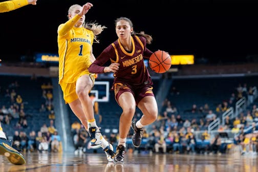 The Gophers' Amaya Battle, right, tries to get past Michigan defender Olivia Olson on Monday, Jan. 5, 2026, in Ann Arbor, Mich. (Brad Rempel, Gophers athletics)