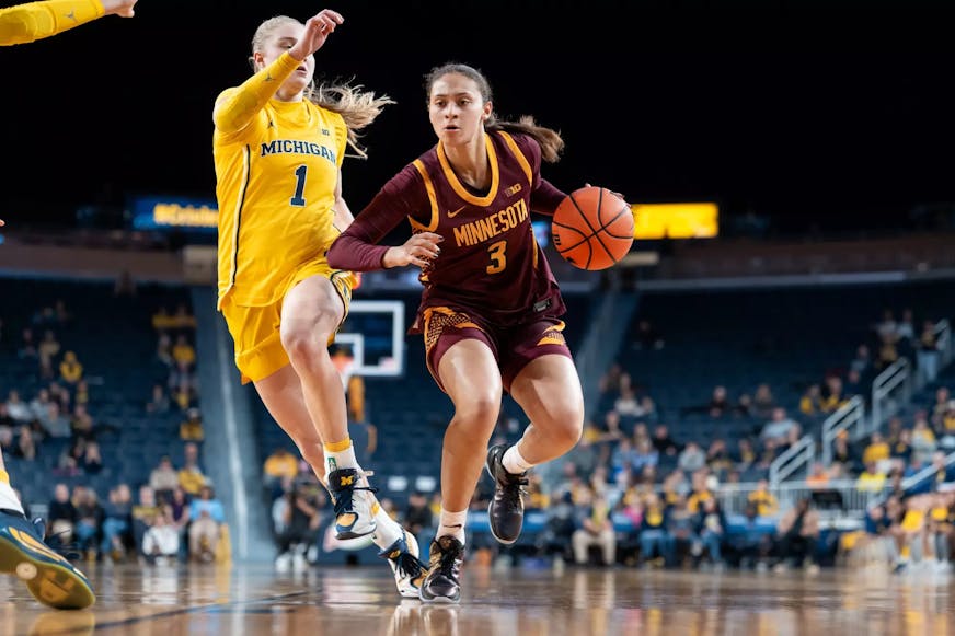 The Gophers' Amaya Battle, right, tries to get past Michigan defender Olivia Olson on Monday, Jan. 5, 2026, in Ann Arbor, Mich. (Brad Rempel, Gophers athletics)