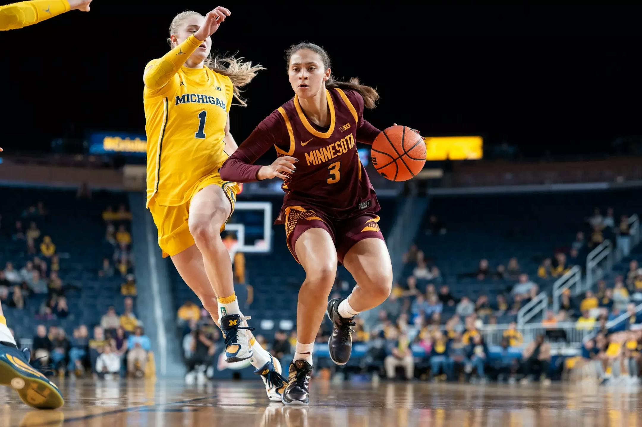 The Gophers' Amaya Battle, right, tries to get past Michigan defender Olivia Olson on Monday, Jan. 5, 2026, in Ann Arbor, Mich. (Brad Rempel, Gophers athletics)