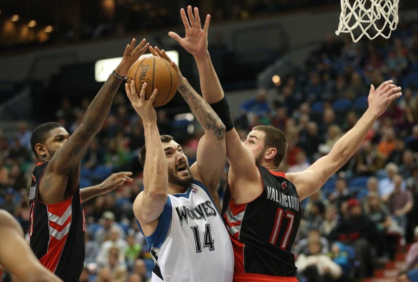 In this April 2013 file photo, Wolves center Nikola Pekovic split the Raptor defense and drove to the basket.