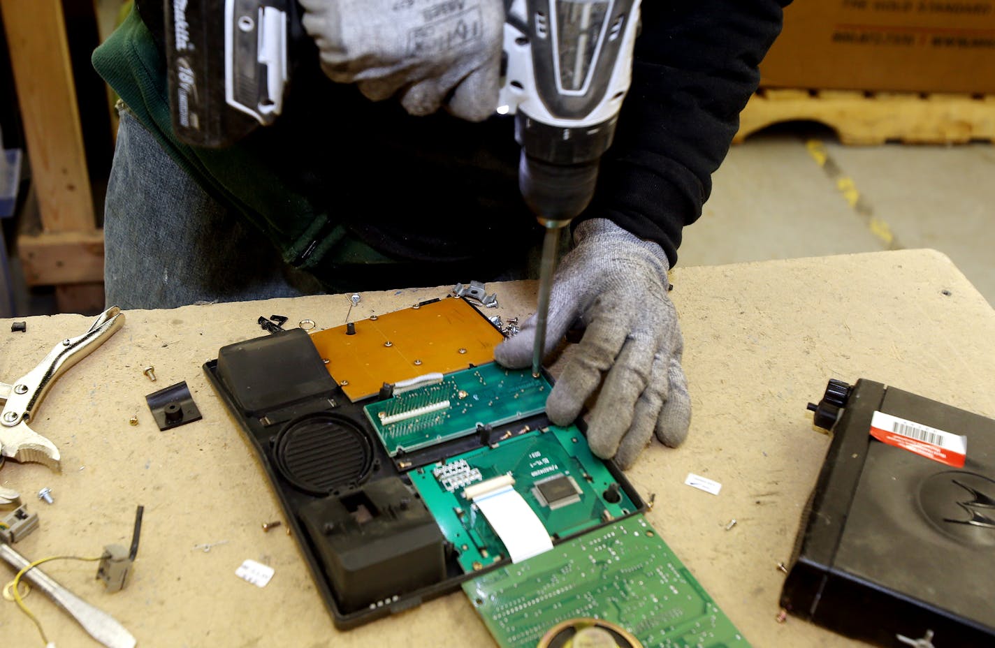 Ben Johnson disassembled a computer parts at the Tech Dump plant. ] JOELKOYAMA&#x201a;&#xc4;&#xa2;jkoyama@startribune Golden Valley, MN on February 3, 2014. A couple of successful business guys looking to "give back," are behind a several-year-old nonprofit consumer-electronics recycling service in Golden Valley that expects this year to double the 2 million pounds of product it took in last year and double employment from 20 to 40. Tech Dump mostly hires ex-inmates and pays them up to $12 an ho