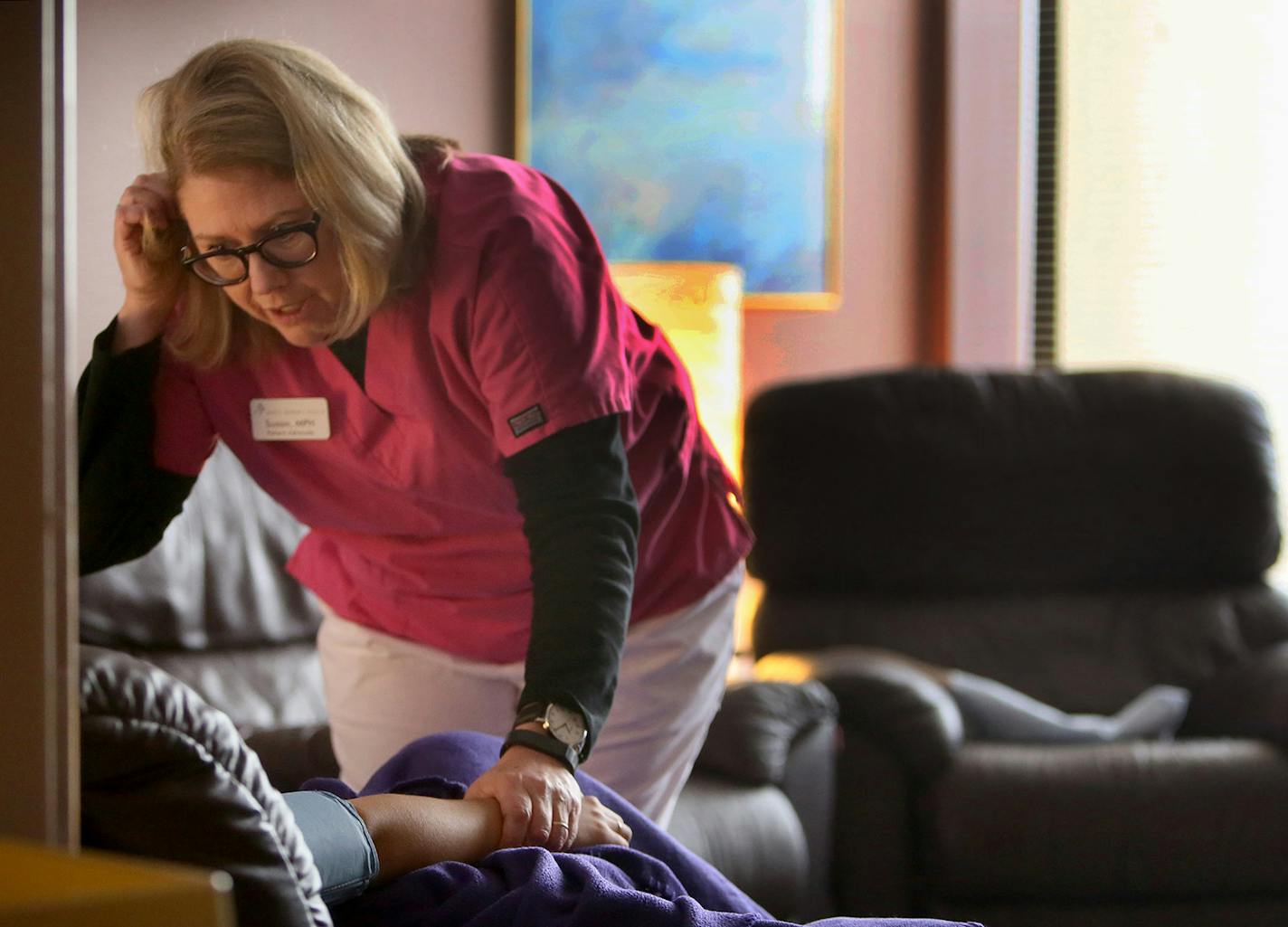 Susan Schumacher, clinical coordinator at Whole Women's Health, checks the pulse and offers comfort to a young woman who has just had an abortion Thursday, Jan. 15, 2015, at Whole Women's Health in Minneapolis, MN.](DAVID JOLES/STARTRIBUNE)djoles@startribune.com As the nation marks the 42nd anniversary of Roe v. Wade, Whole Women's Health in Minneapolis goes about the business of offering abortions to women who seek them out -- including large numbers who travel hundreds of miles from states wit