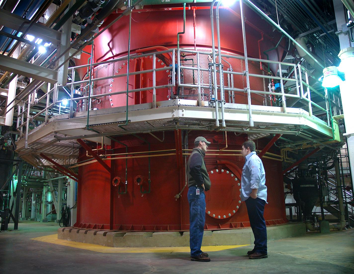 Workers stand in front of one of three incinerators at the Metropolitan Council's Metro wastewater treatment plant in St. Paul. The plant is due to receive an extra incinerator in the coming years.