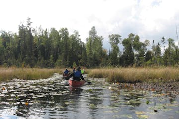 This Sept. 16, 2017 photo shows two canoes along a lily pad-lined bog in Minnesota's Boundary Waters Canoe Area Wilderness. The area protects more tha