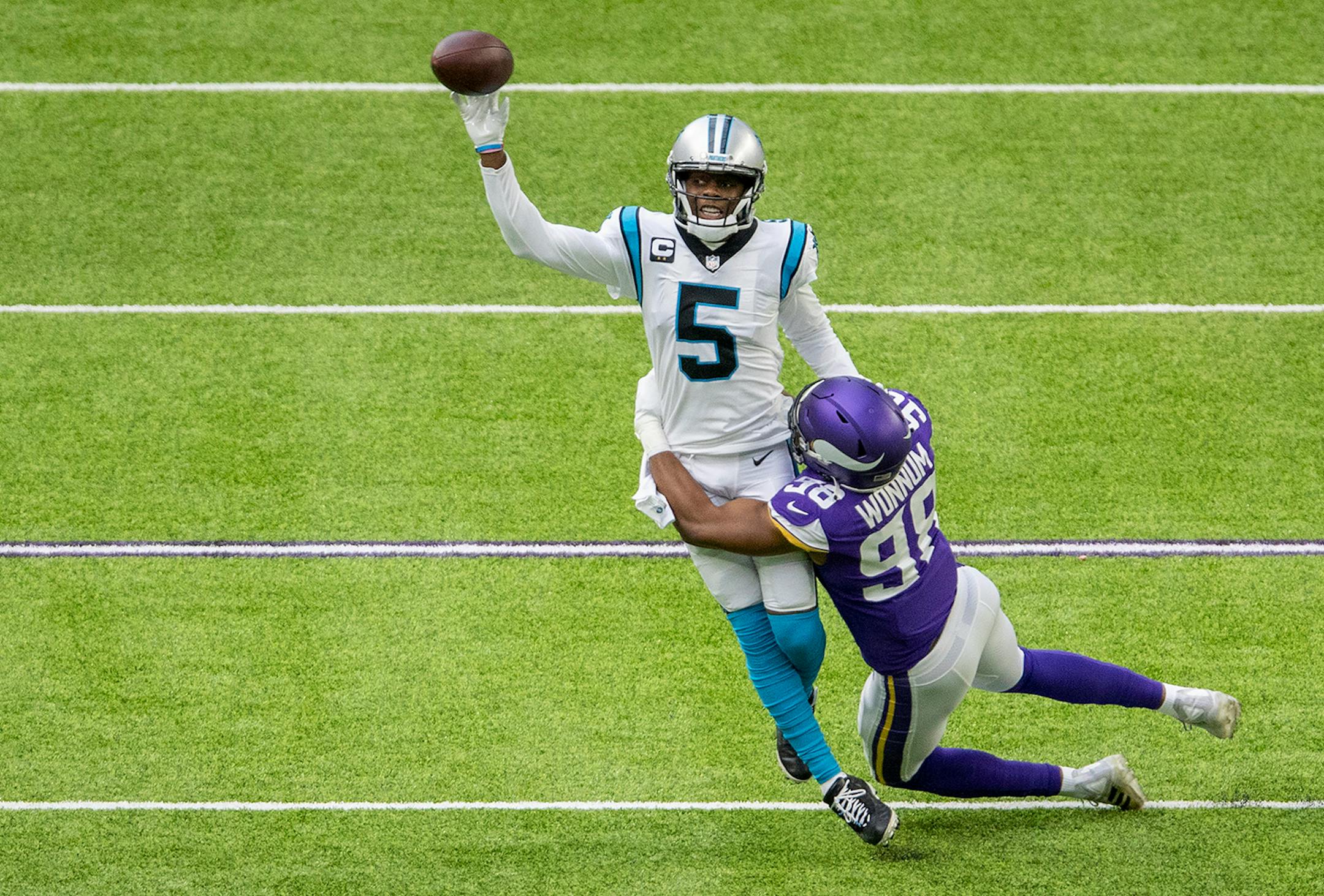 Carolina Panthers quarterback Teddy Bridgewater (5) was pressured by D.J. Wonnum (98) of the Minnesota Vikings in the first quarter.
