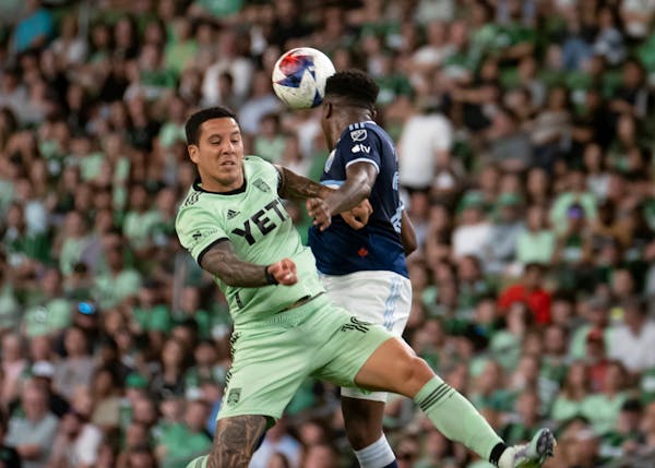 Austin FC midfielder Sebastián Driussi, left, contested for the ball against Vancouver Whitecaps defender Javain Brown on April 15, 2023.
