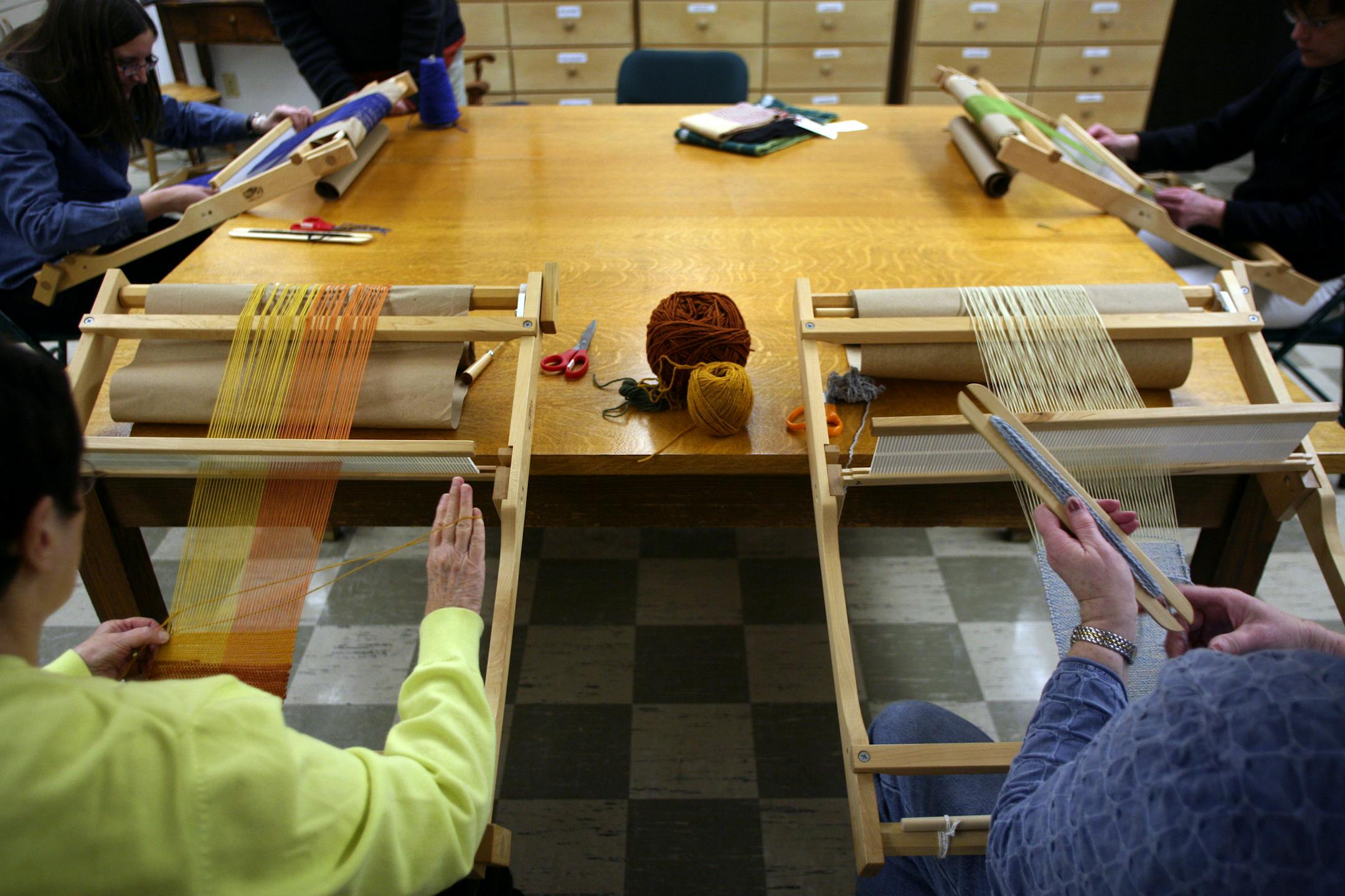 Clockwise from upper left: Diane Bartelt, Lorrie Hansen, Sharon Tocko and Mary Joe Dolan worked at their looms during a class at the Benedictine Center that approaches weaving as a spiritual practice. The center, at St. Paul's Monastery in Maplewood, holds the classes to combine Benedictine teachings with modern life.