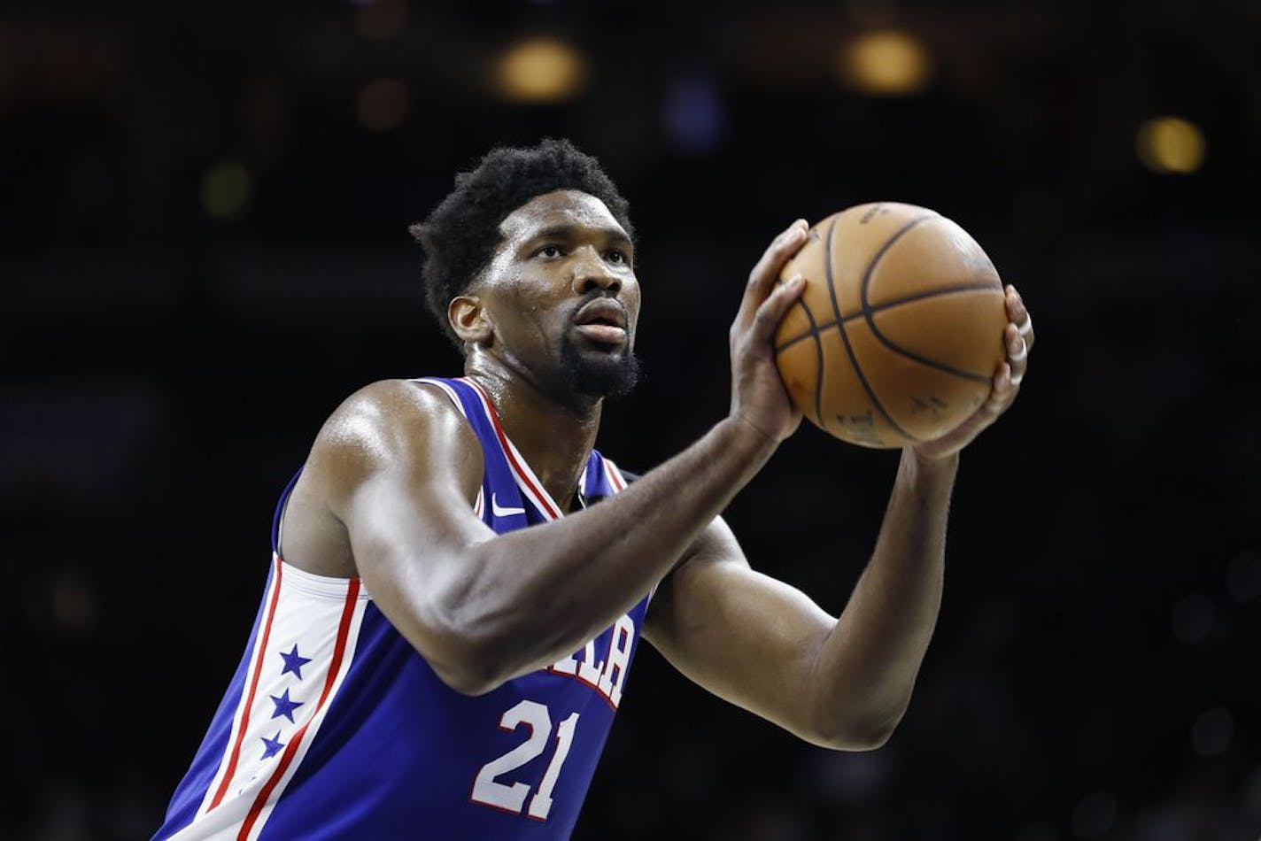 FILE - In this March 11, 2020 file photo, Philadelphia 76ers' Joel Embiid plays during an NBA basketball game against the Detroit Pistons in Philadelphia. Embiid is hurting, and that's a cause for concern as the Philadelphia 76ers get set to restart their season this week. The All-Star starting center sat out Philadelphia's scrimmage against Oklahoma City on Sunday, July 26 with right calf tightness, something 76ers coach Brett Brown hopes is merely a minor blip.