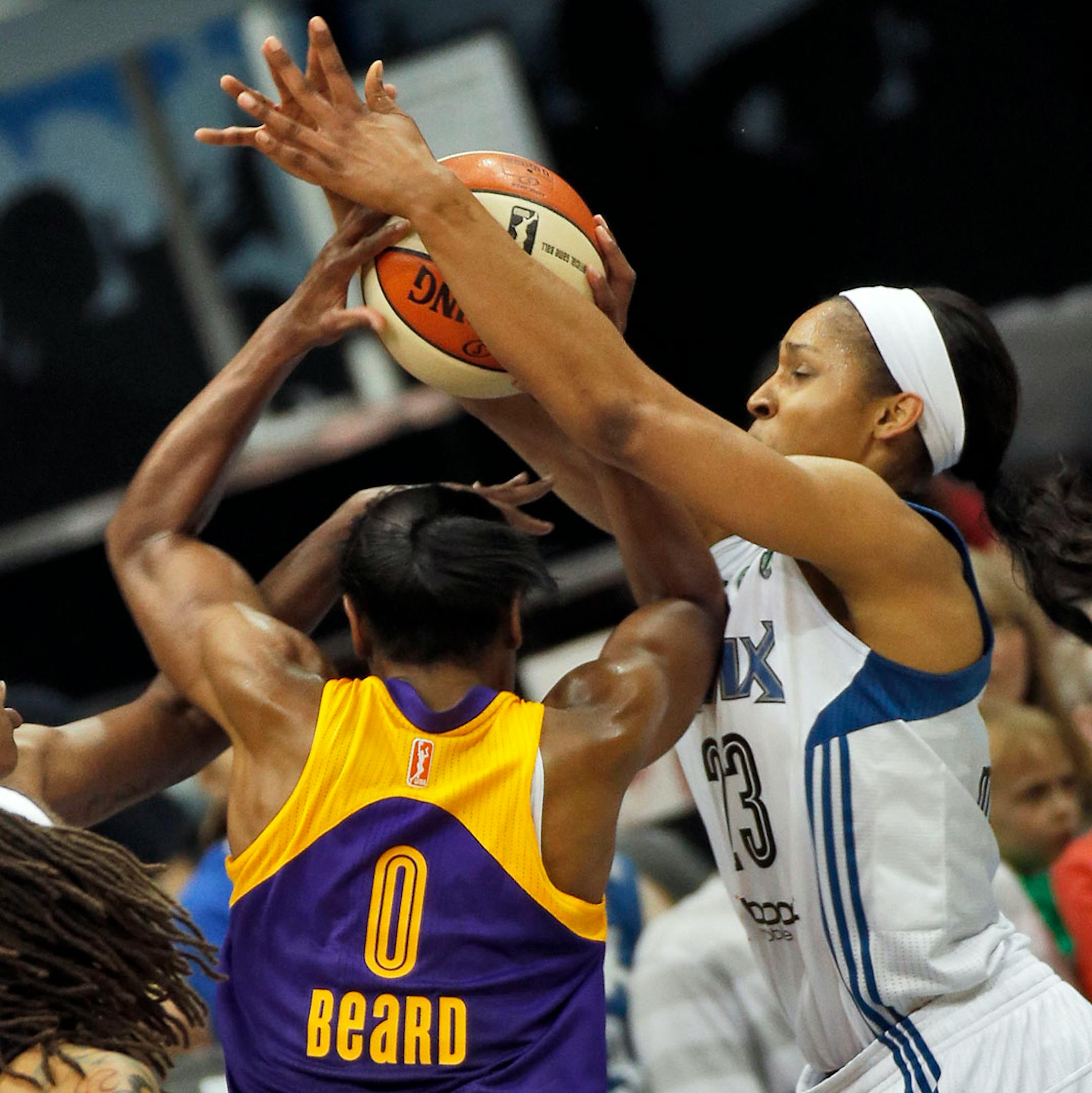 The Lynx's Maya Moore, right, blocked the shot of the Sparks' Alana Beard.
