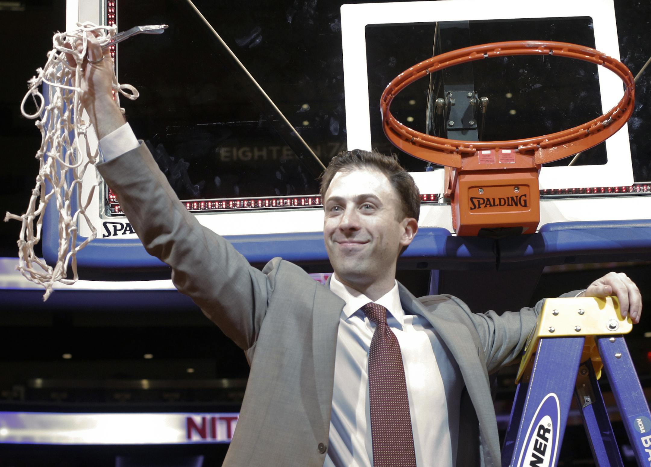 Minnesota head coach Richard Pitino waves to a crowd after cutting down the net after an NCAA college basketball game against SMU in the finals of the NIT Thursday, April 3, 2014, in New York. Minnesota won the game 65-63. (AP Photo/Frank Franklin II) ORG XMIT: NYOTK