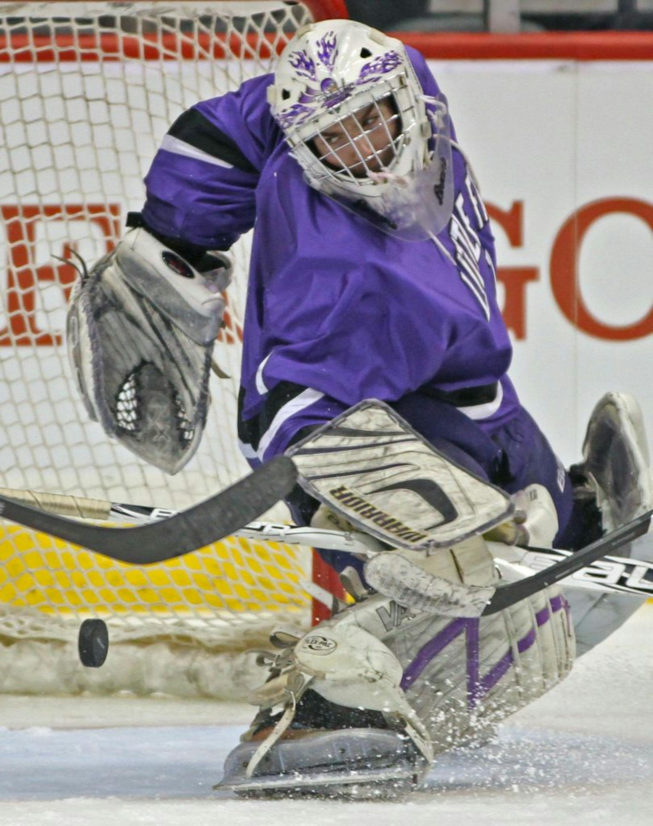 Boys State Hockey Tournament, Class A quarterfinals, St. Thomas Academy vs. Little Falls, 3/7/12. (left to right) Little Falls goalie Michael Stumpf looked back as St. Thomas Academy's Tom Novak shot on goal went in for the 5th Mustang goal.