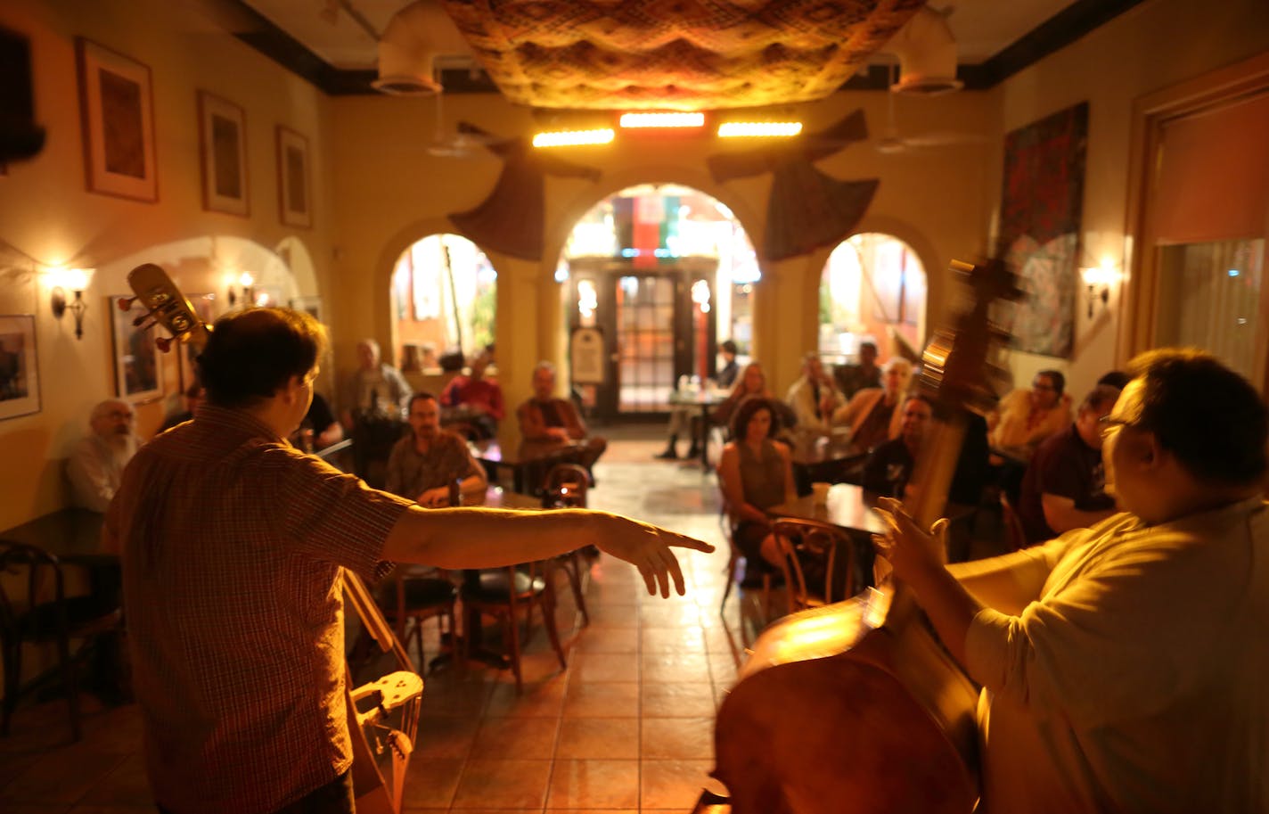 Chris Bates, left, introduced Adam Linz before they began their set of bass duets to kick off a night of jazz at Khyber Pass Cafe in St. Paul this month.