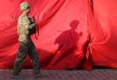 A U.S. soldier walks towards the site of a suicide attack in the heart of Kabul, Afghanistan, Saturday, Aug. 22, 2015. The suicide car bomber attacked