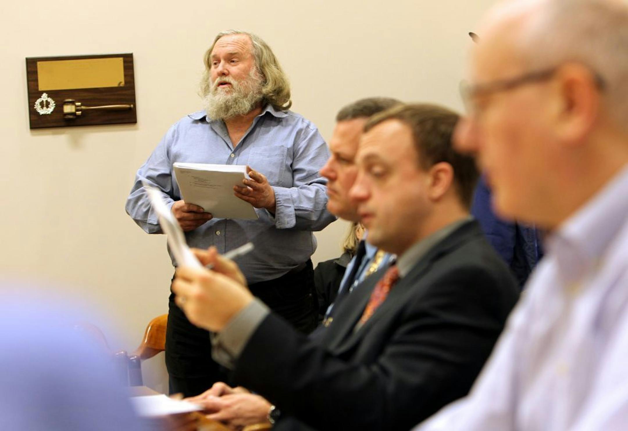 Minneapolis resident Dave Bicking, left, stands to present his concerns during the public invitation portion of the regular monthly board meeting of the Minneapolis Civilian Police Review Authority at Minneapolis City Hall February 1, 2012.