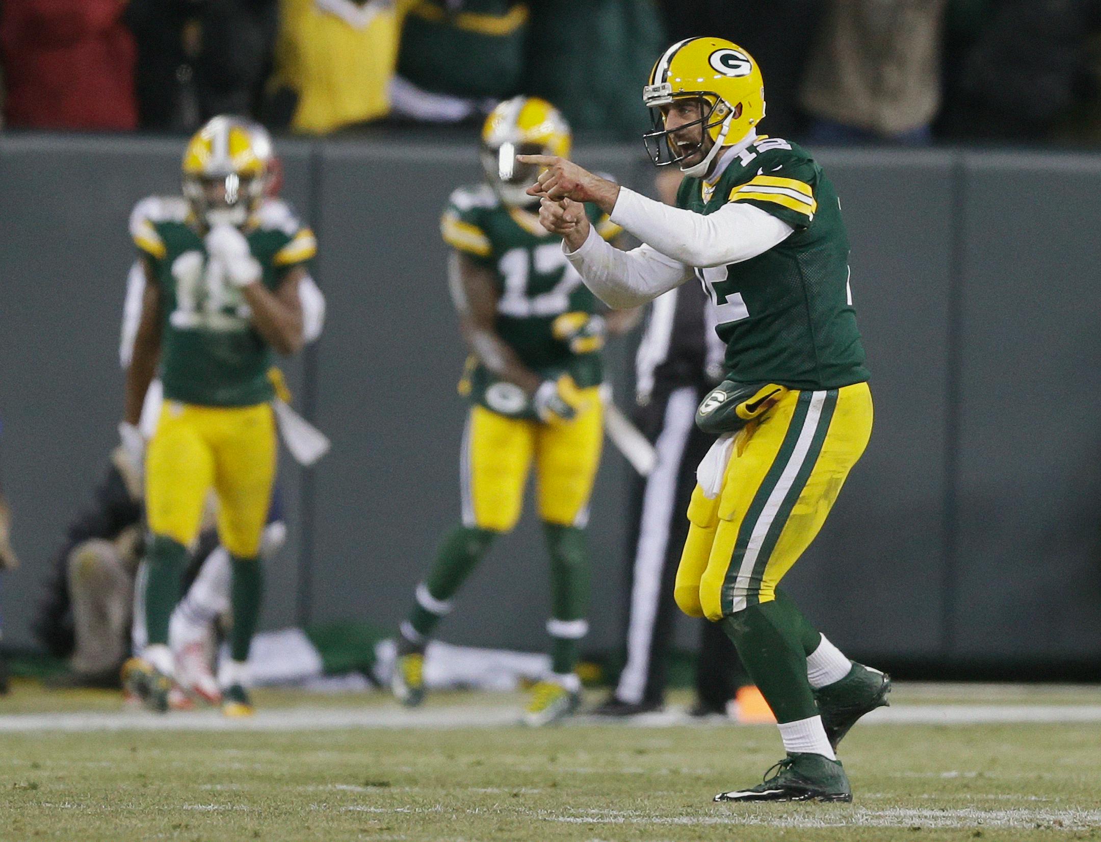 Green Bay Packers quarterback Aaron Rodgers celebrates a 45-yard touchdown pass to Jordy Nelson during the first half of an NFL football game against the New England Patriots Sunday, Nov. 30, 2014, in Green Bay, Wis. (AP Photo/Tom Lynn)