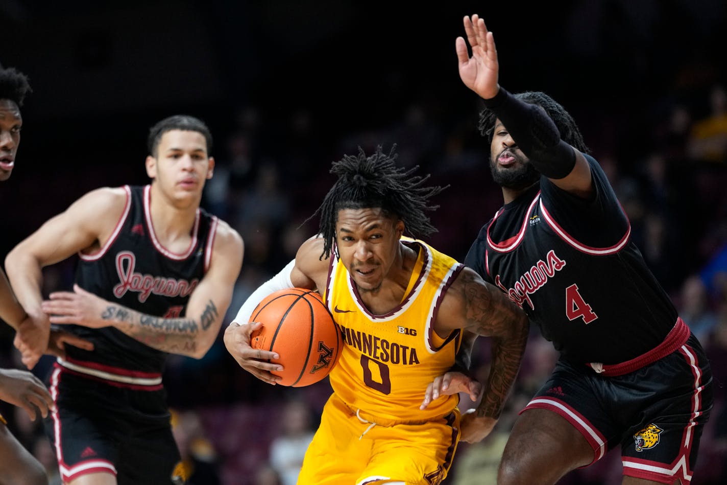 Minnesota guard Elijah Hawkins (0) works toward the basket as IUPUI guard Bryce Monroe (4) defends during the first half of an NCAA college basketball game Tuesday, Dec. 12, 2023, in Minneapolis. (AP Photo/Abbie Parr)