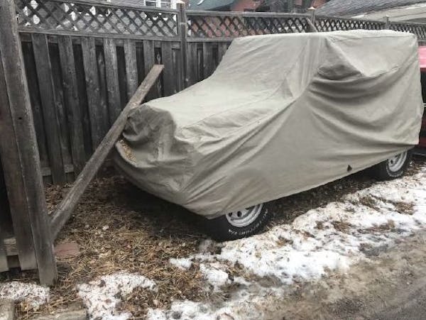 A city inspector took this photo of a vehicle parked on Rep. John Lesch's property. He was cited in December for two vehicles being parked on an "unim