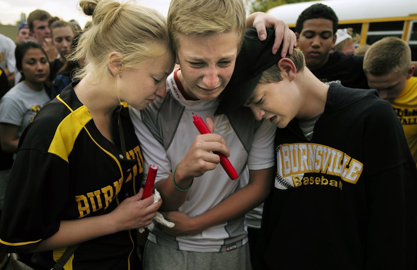 On a sport field at Burnsville H.S. on July 7, 2014, sibilings Cassie, Drew, and Trace Alyea grieved for the loss of their sibling Ty at a vigil where Burnsville students gathered to lend their support. ] Richard Tsong-Taatarii/rtsong-taatarii@startribune.com