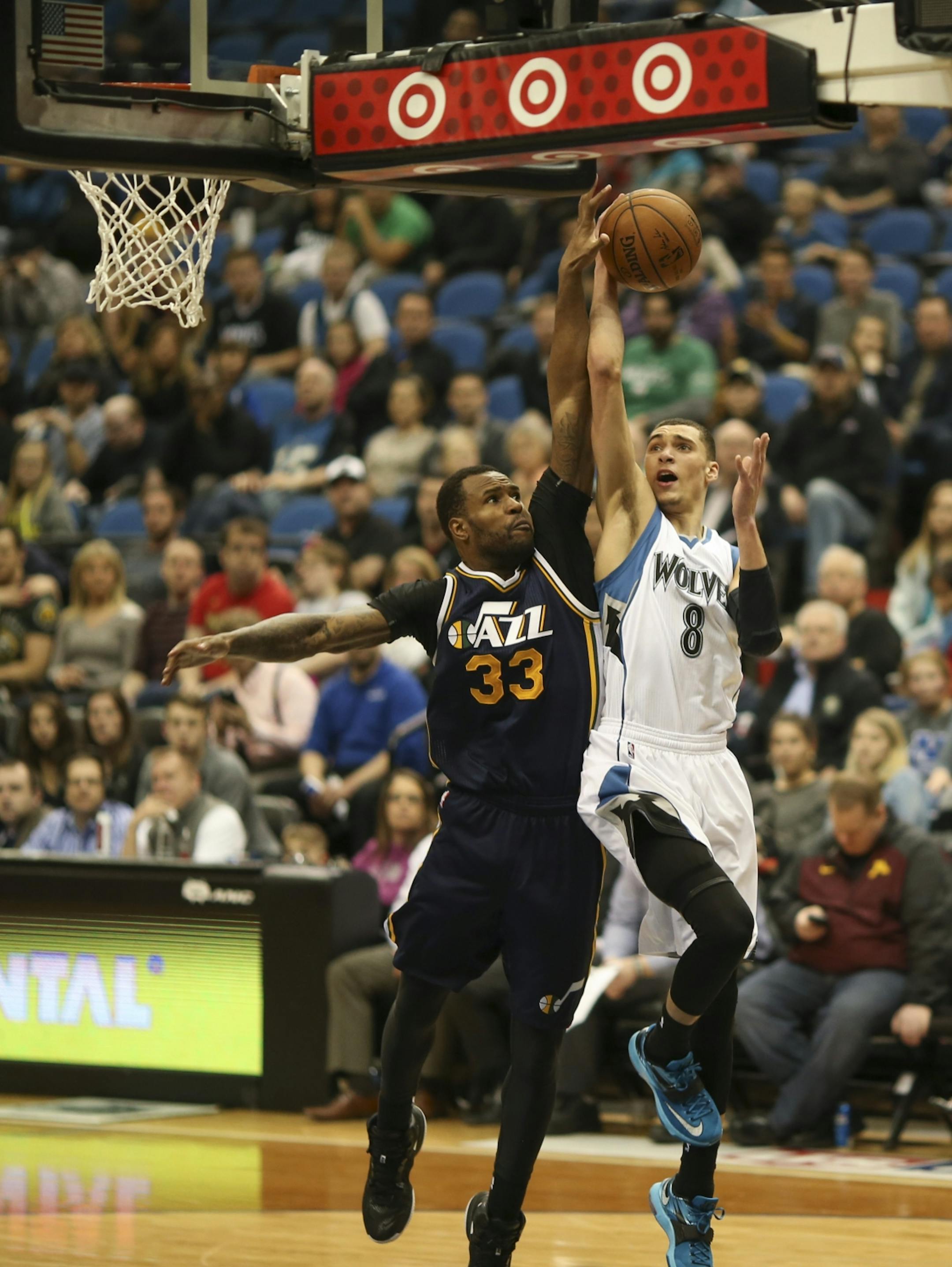 Utah Jazz forward Trevor Booker fouled Timberwolves guard Zach LaVine on his way to the hoop in the fourth quarter Monday night at Target Center. LaVine led the Wolves with 21 points for the night.